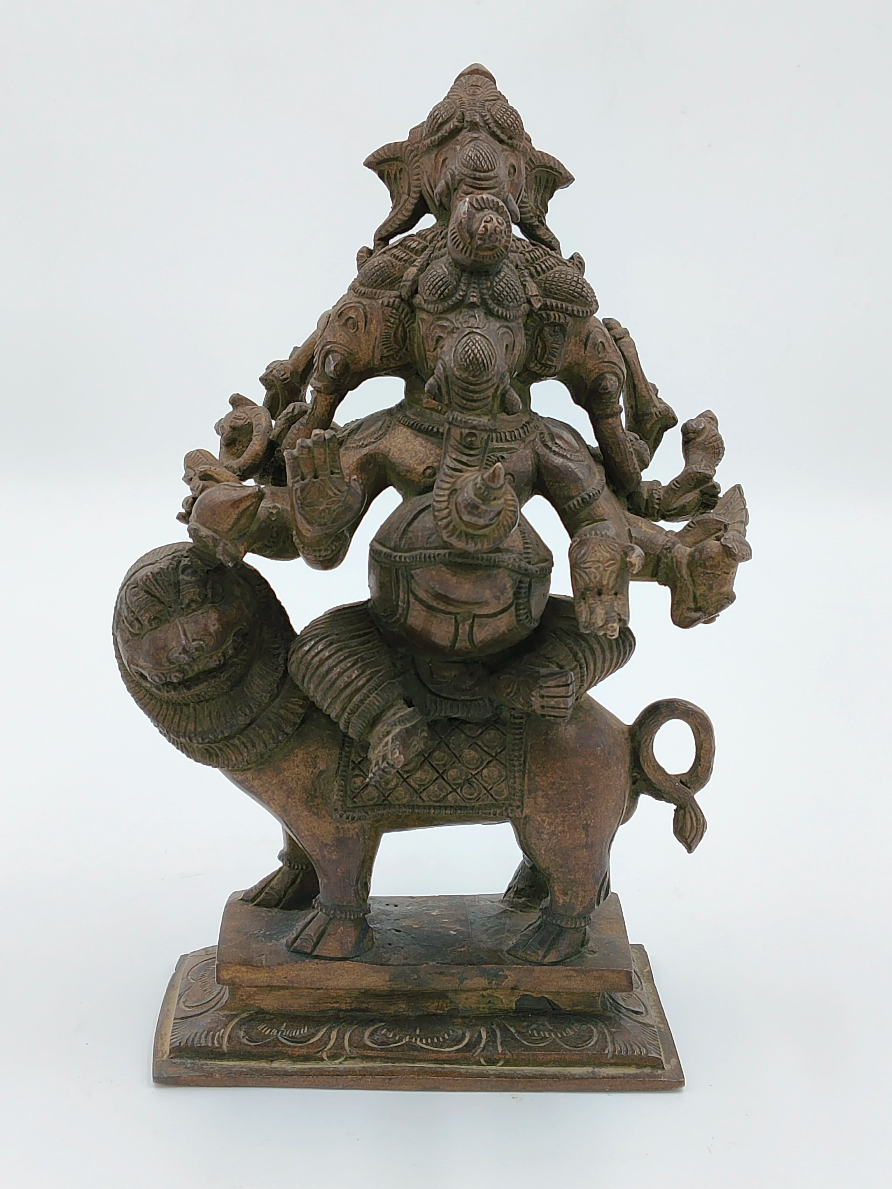 Bronze sculpture of five-faced Ganesh seated on a lion with detailed carvings