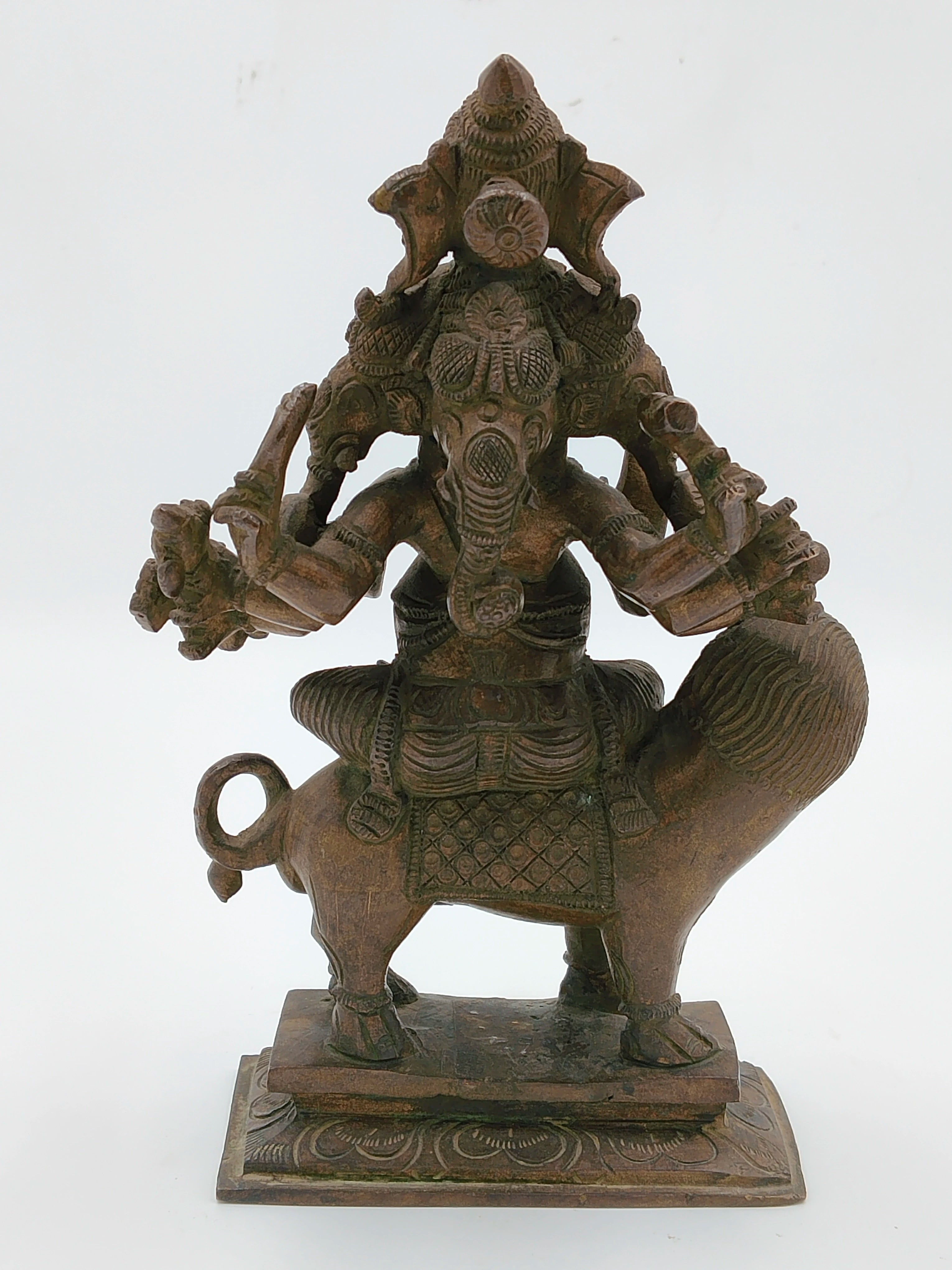 Bronze statue of five-faced Ganesh seated on a lion with detailed carvings