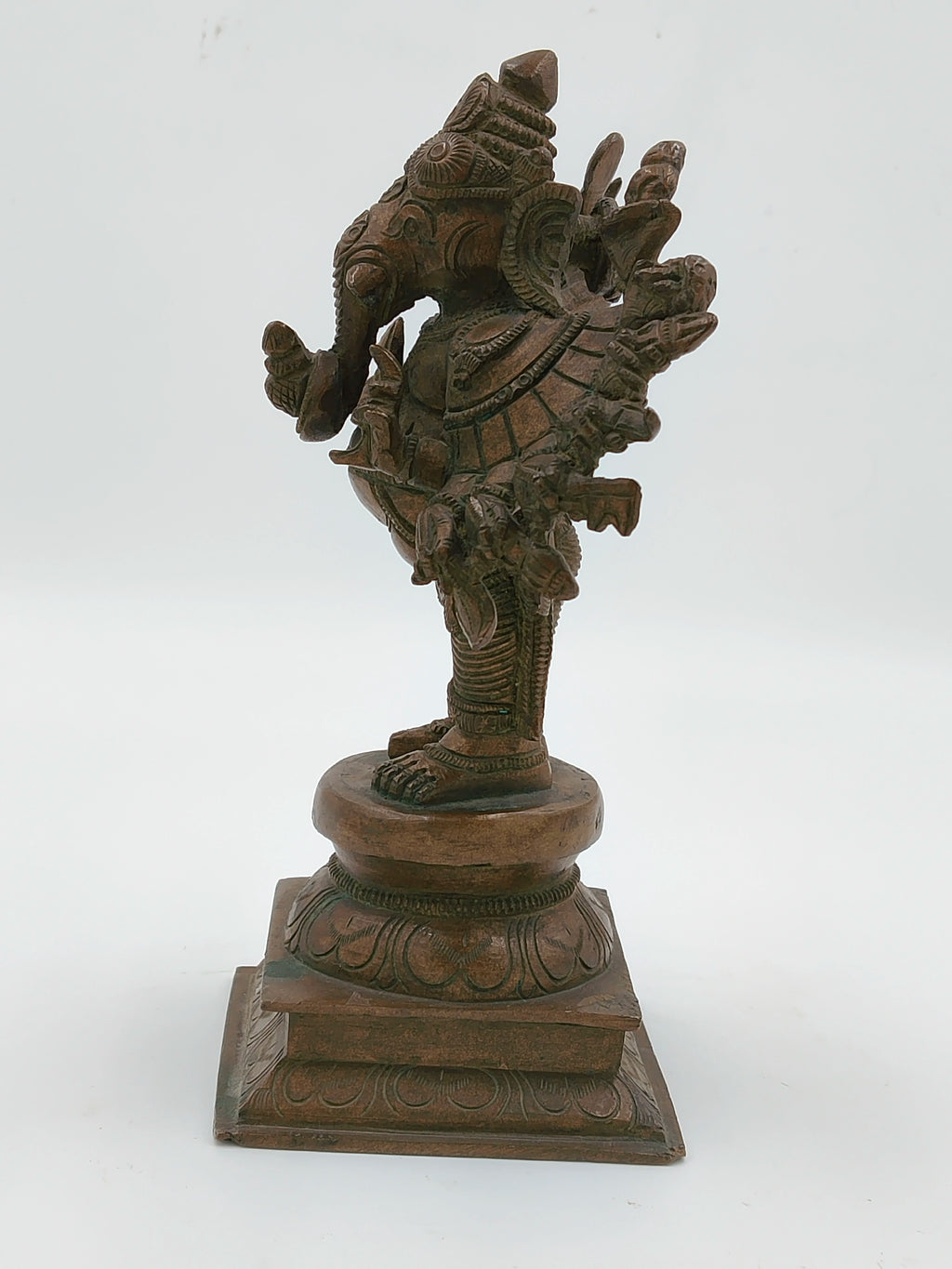 Side view of a bronze Ganesh sculpture with 16 intricately detailed hands