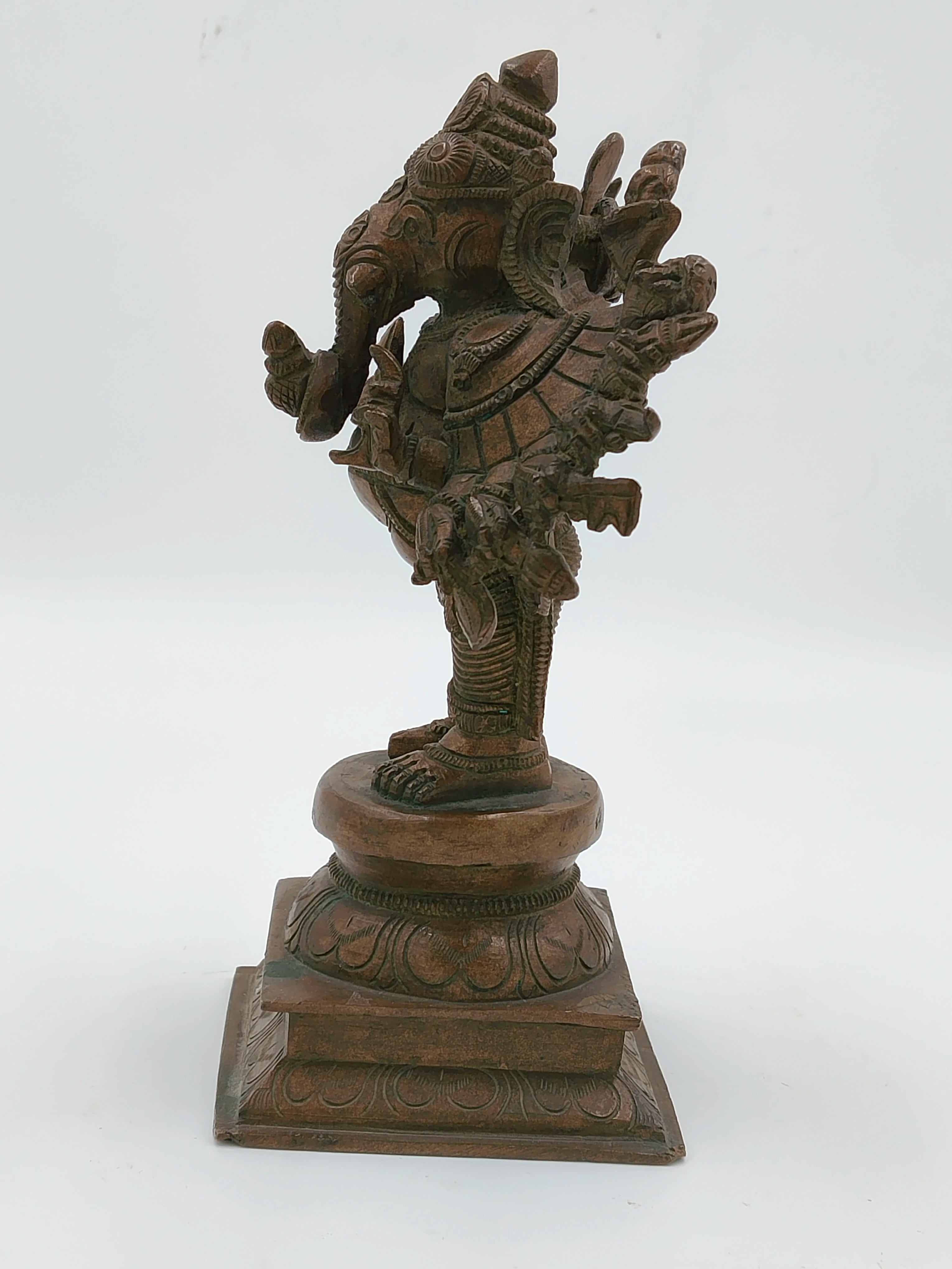 Side view of a bronze Ganesh sculpture with 16 intricately detailed hands