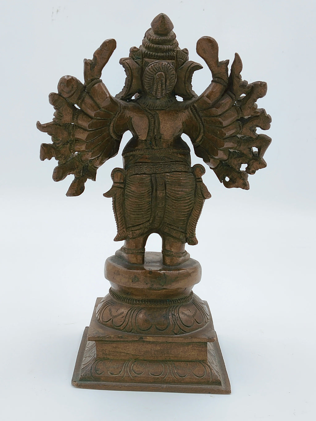 Rear view of bronze Ganesh sculpture with 16 hands on decorative base