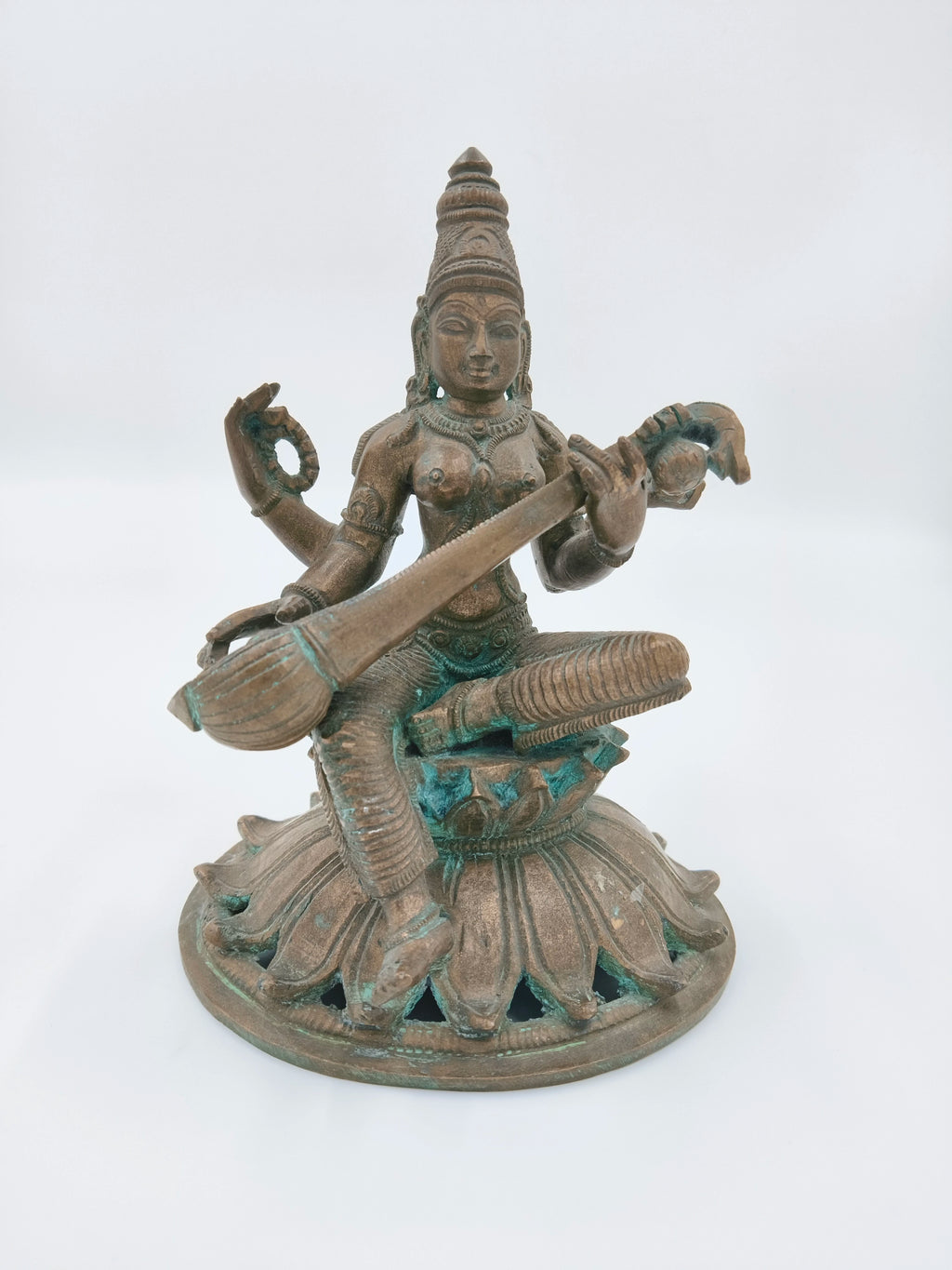 Bronze sculpture of Saraswathi goddess playing veena, seated on lotus base