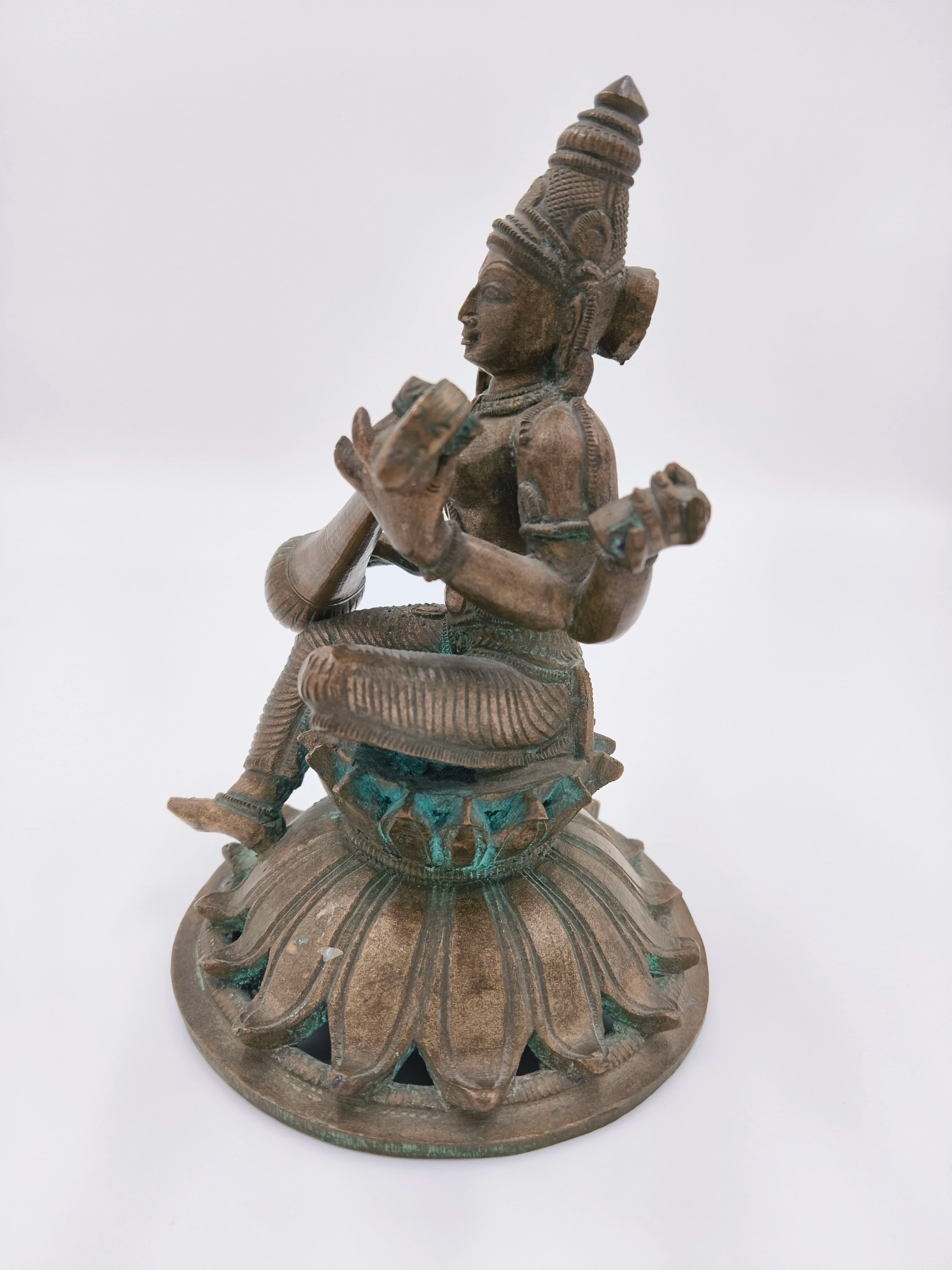 Bronze Saraswathi statue seated on lotus pedestal side view