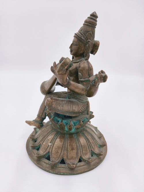 Bronze Saraswathi statue seated on lotus pedestal side view