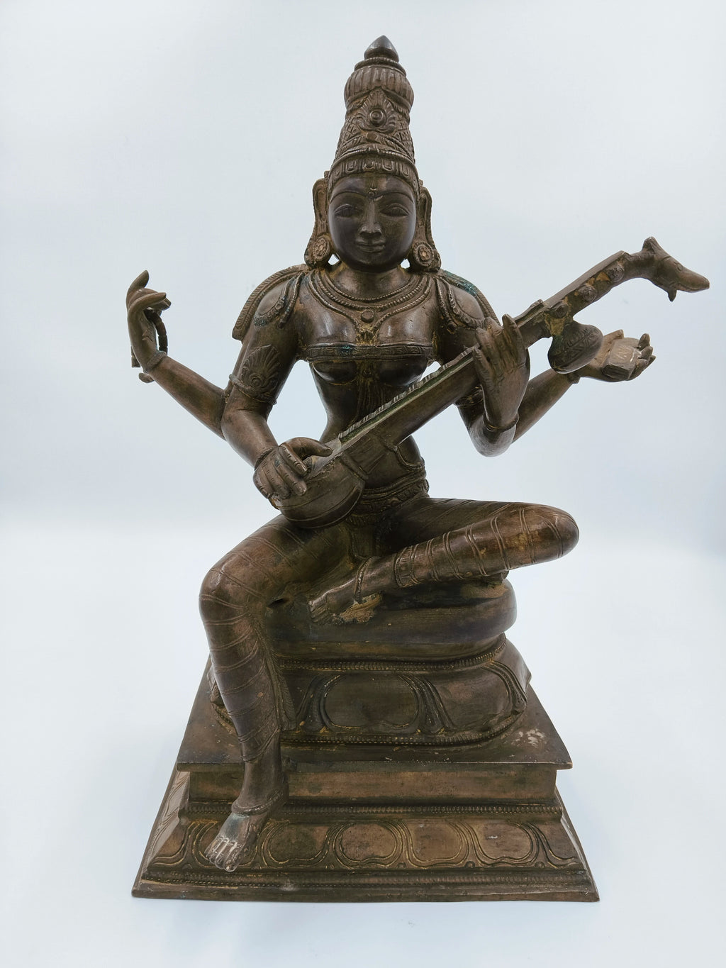 Large bronze sculpture of the deity Saraswathi playing a veena