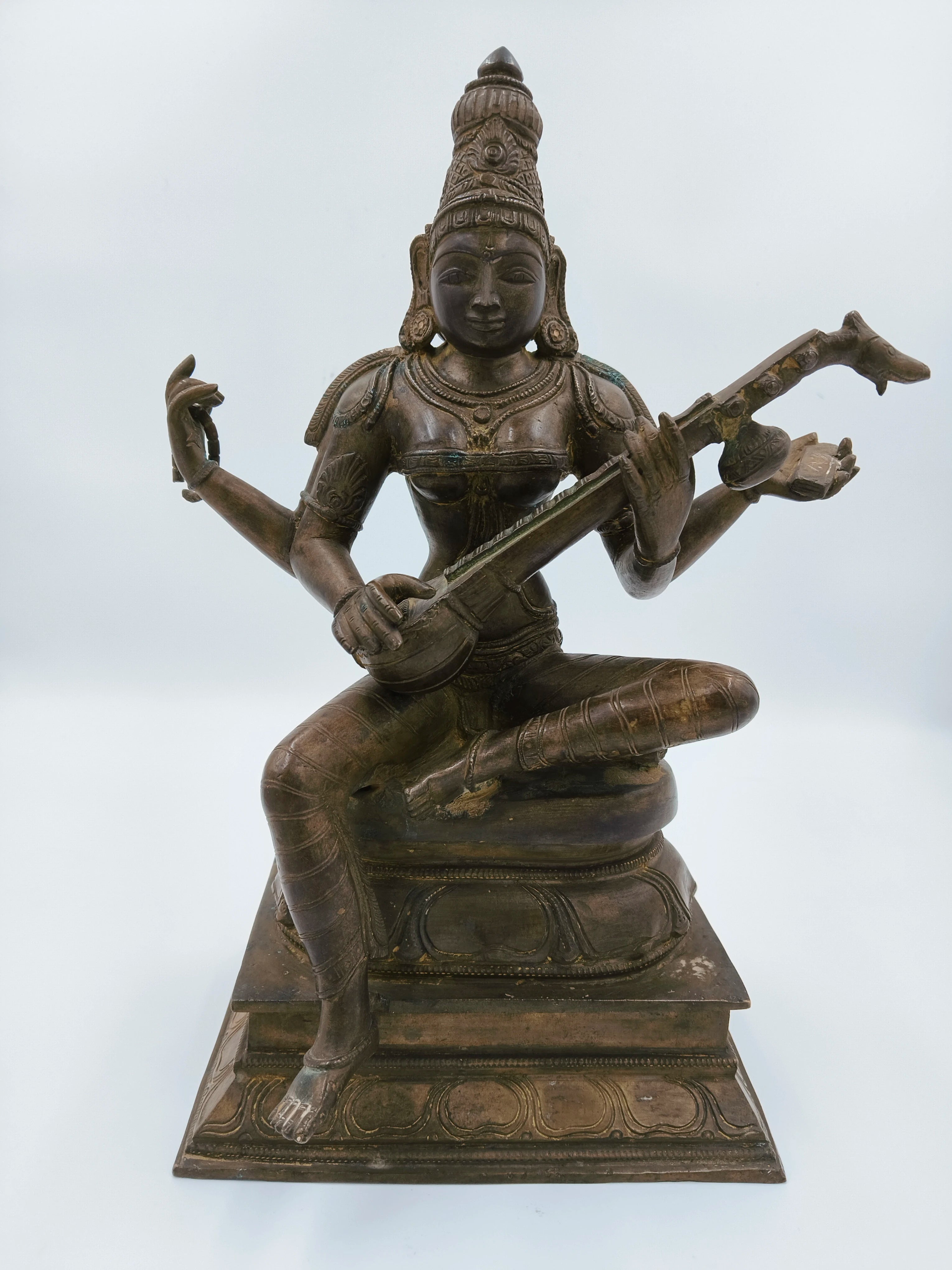 Large bronze sculpture of the deity Saraswathi playing a veena