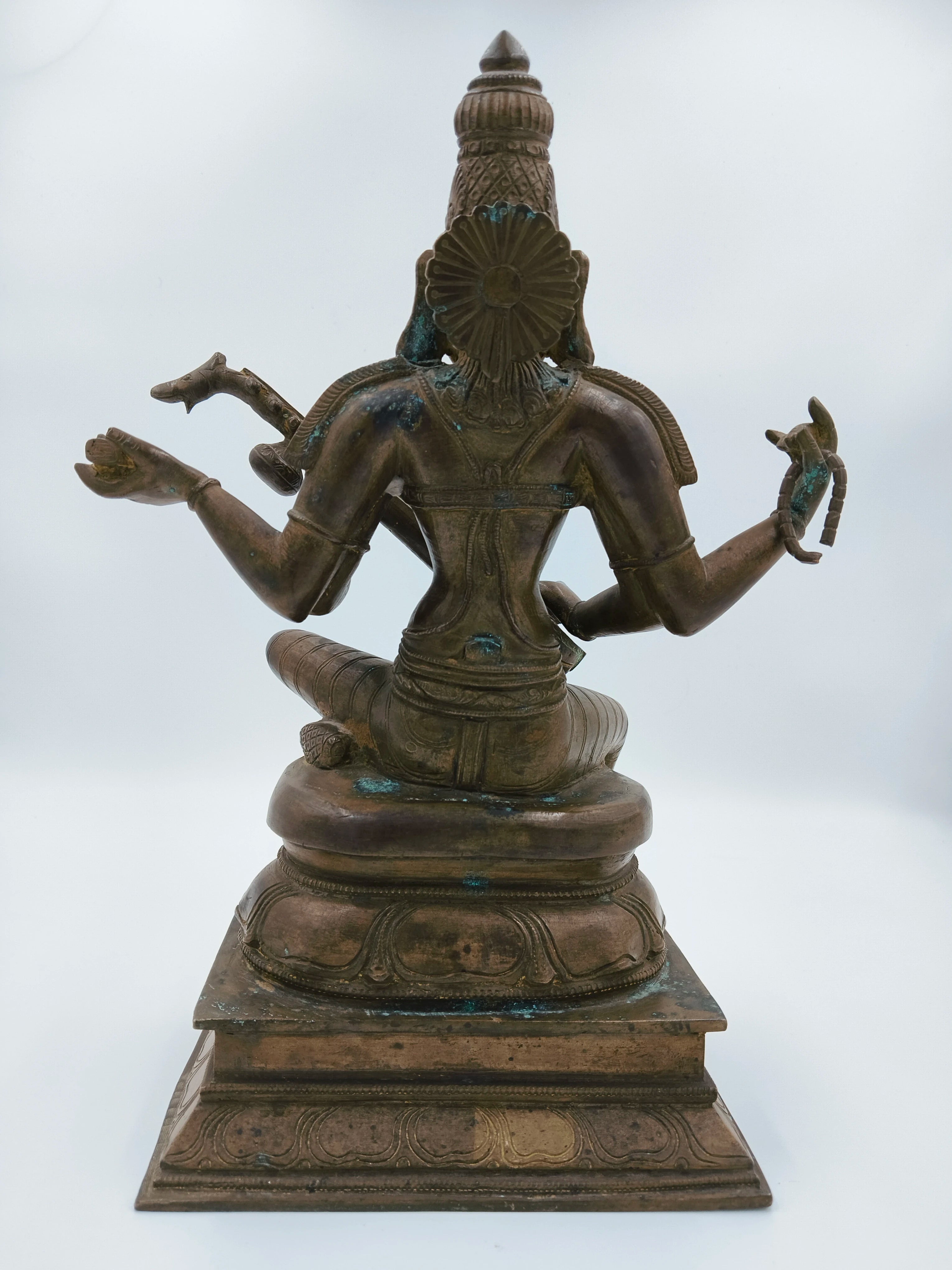 Back view of bronze Saraswathi statue seated on lotus pedestal