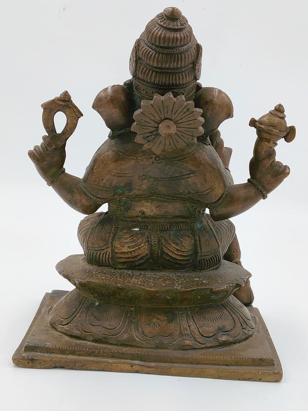 Rear view of large bronze Ganesh sculpture seated on decorative base