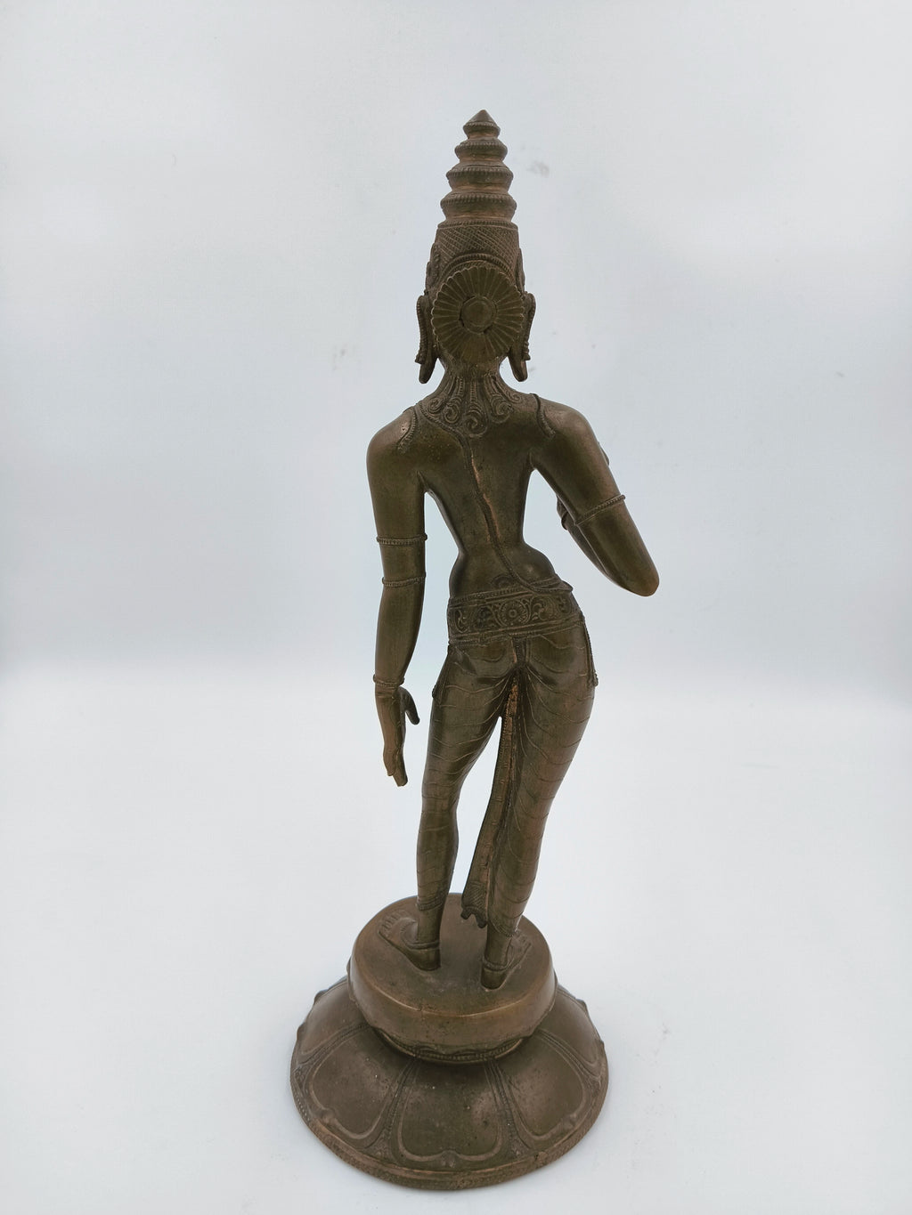 Back view of bronze standing Parvathi sculpture with detailed attire and headdress