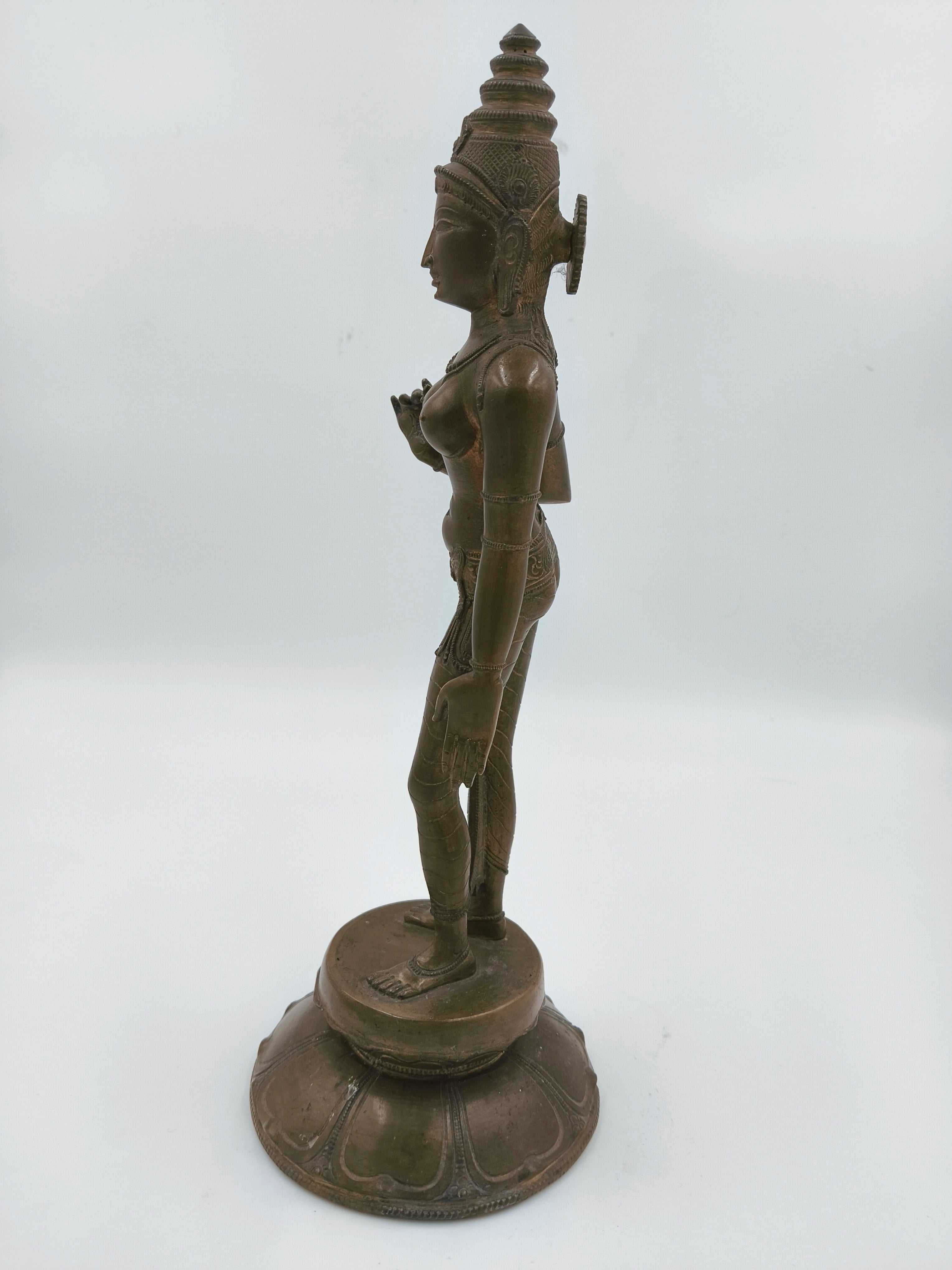 Side view of bronze standing statue of Hindu goddess Parvathi on decorative base