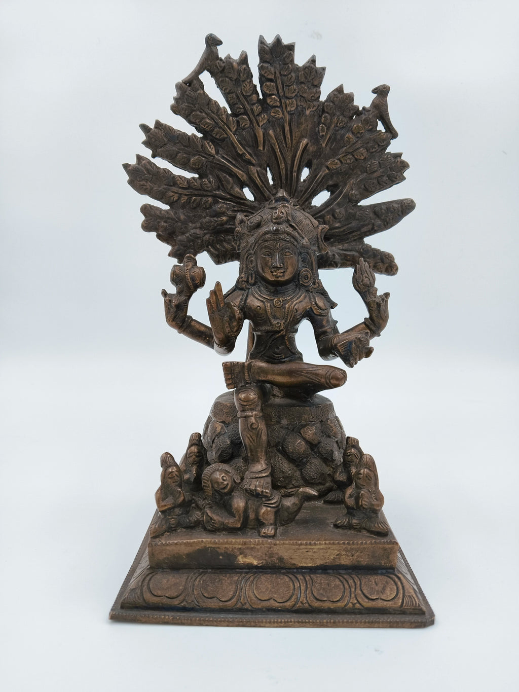 Front view of bronze Dakshanamurthi statue with ornate fan and seated figure