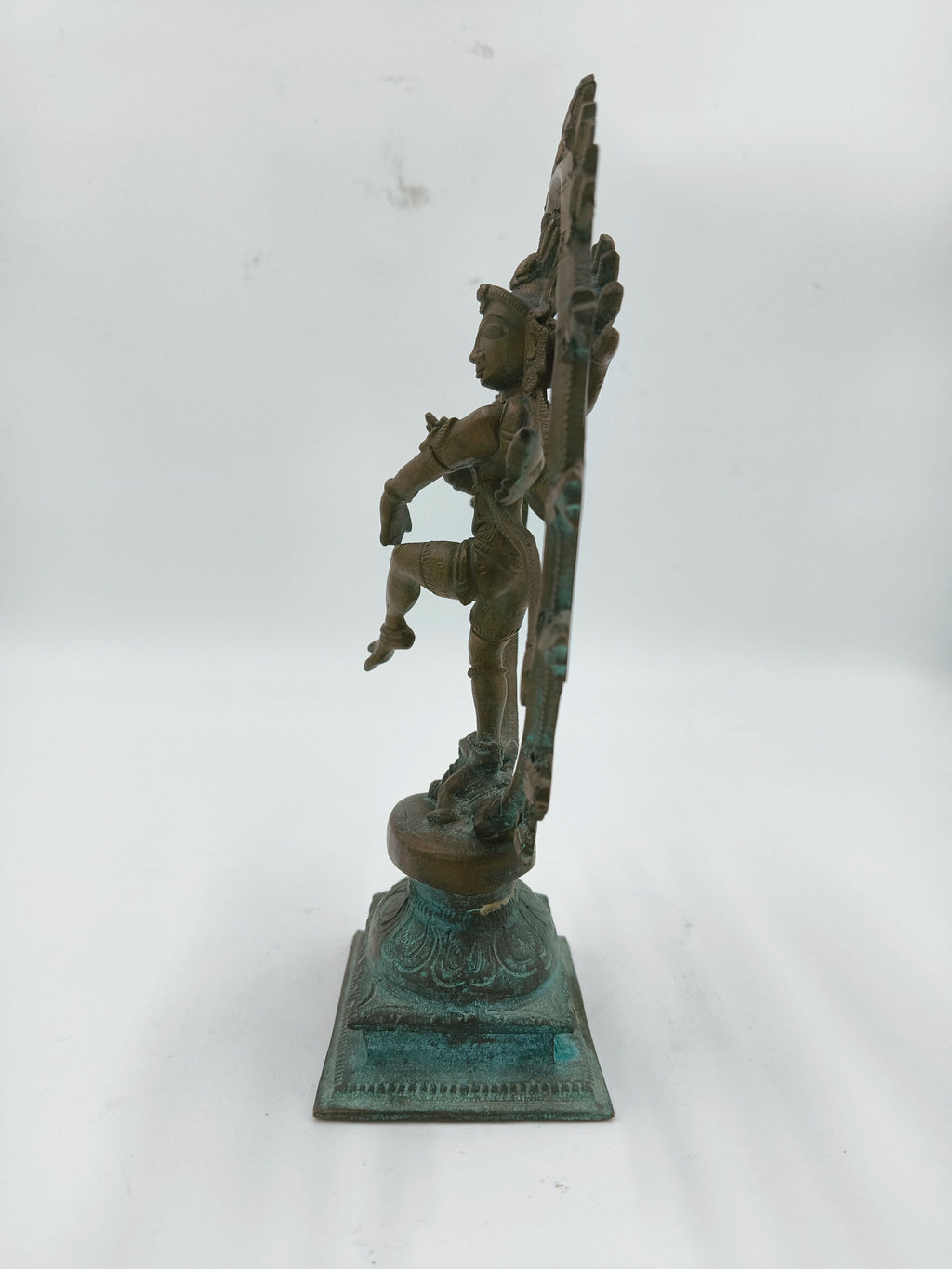Side view of a 7.4 inch bronze Nataraja sculpture on decorative base