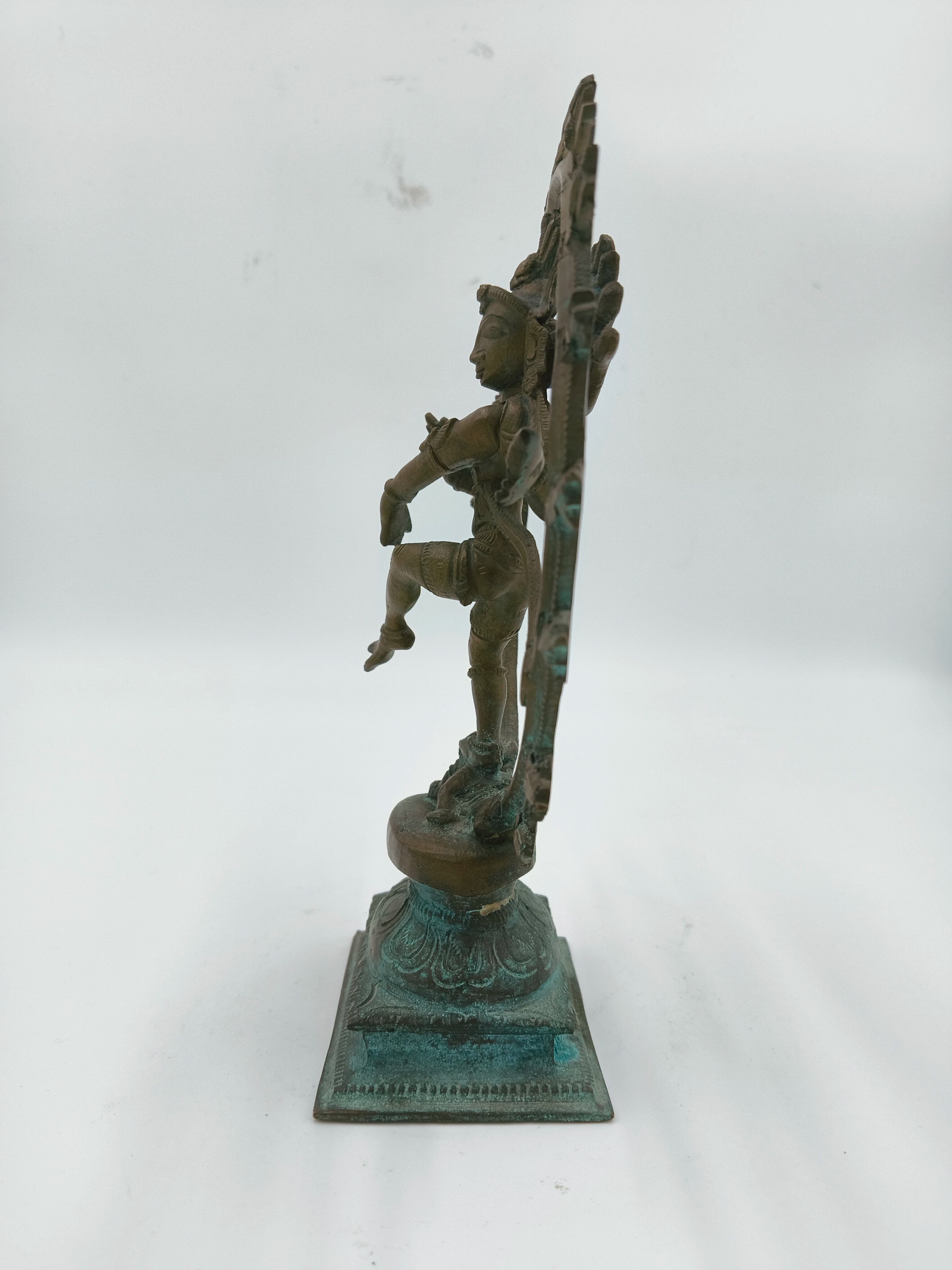 Side view of a 7.4 inch bronze Nataraja sculpture on decorative base