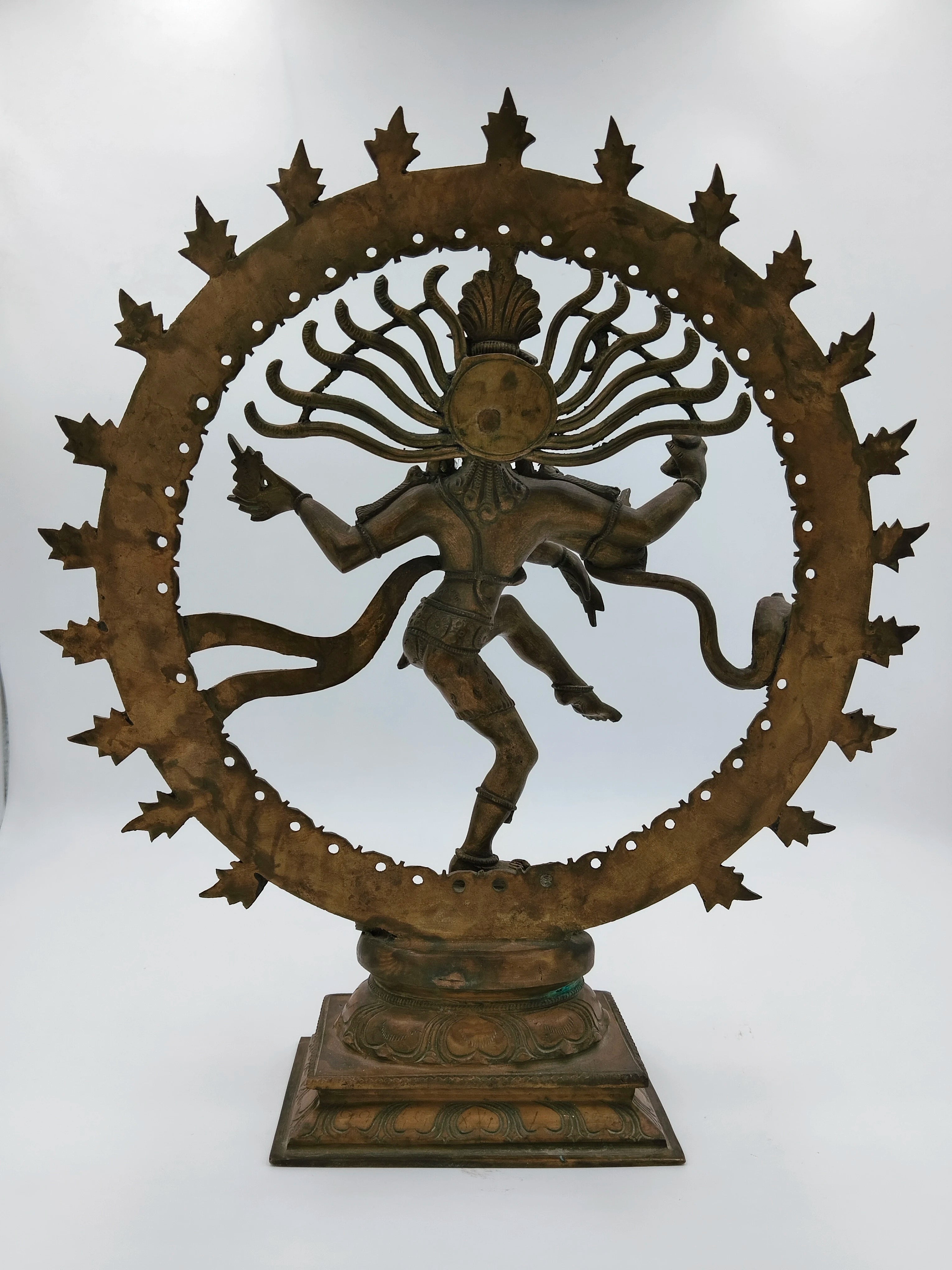 Large bronze Nataraja statue of Shiva in cosmic dance inside circular flame halo