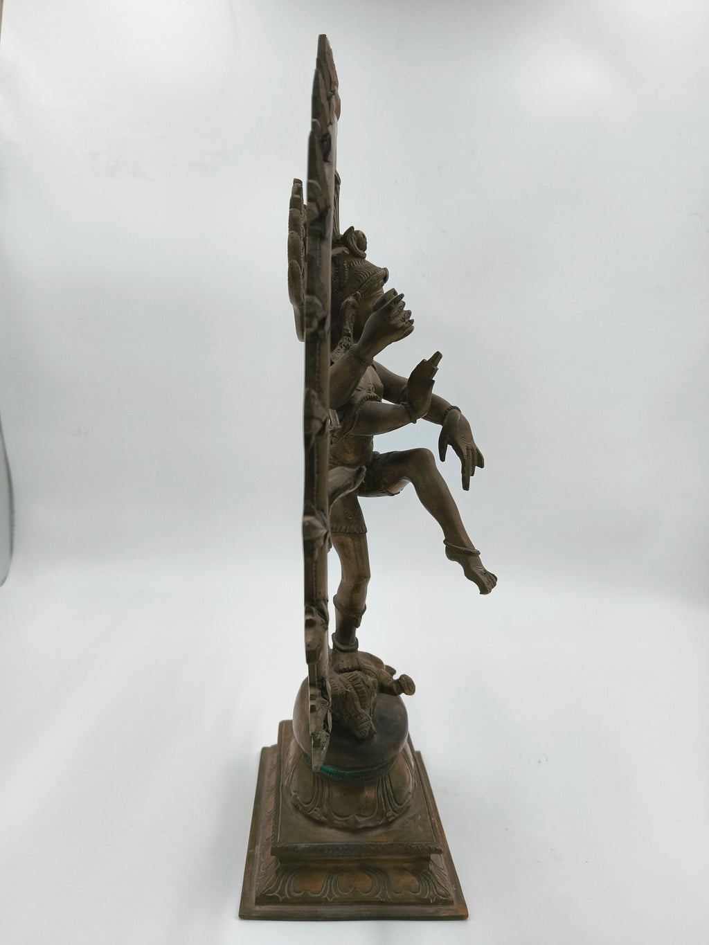 Side view of large bronze Nataraja statue depicting Shiva in cosmic dance