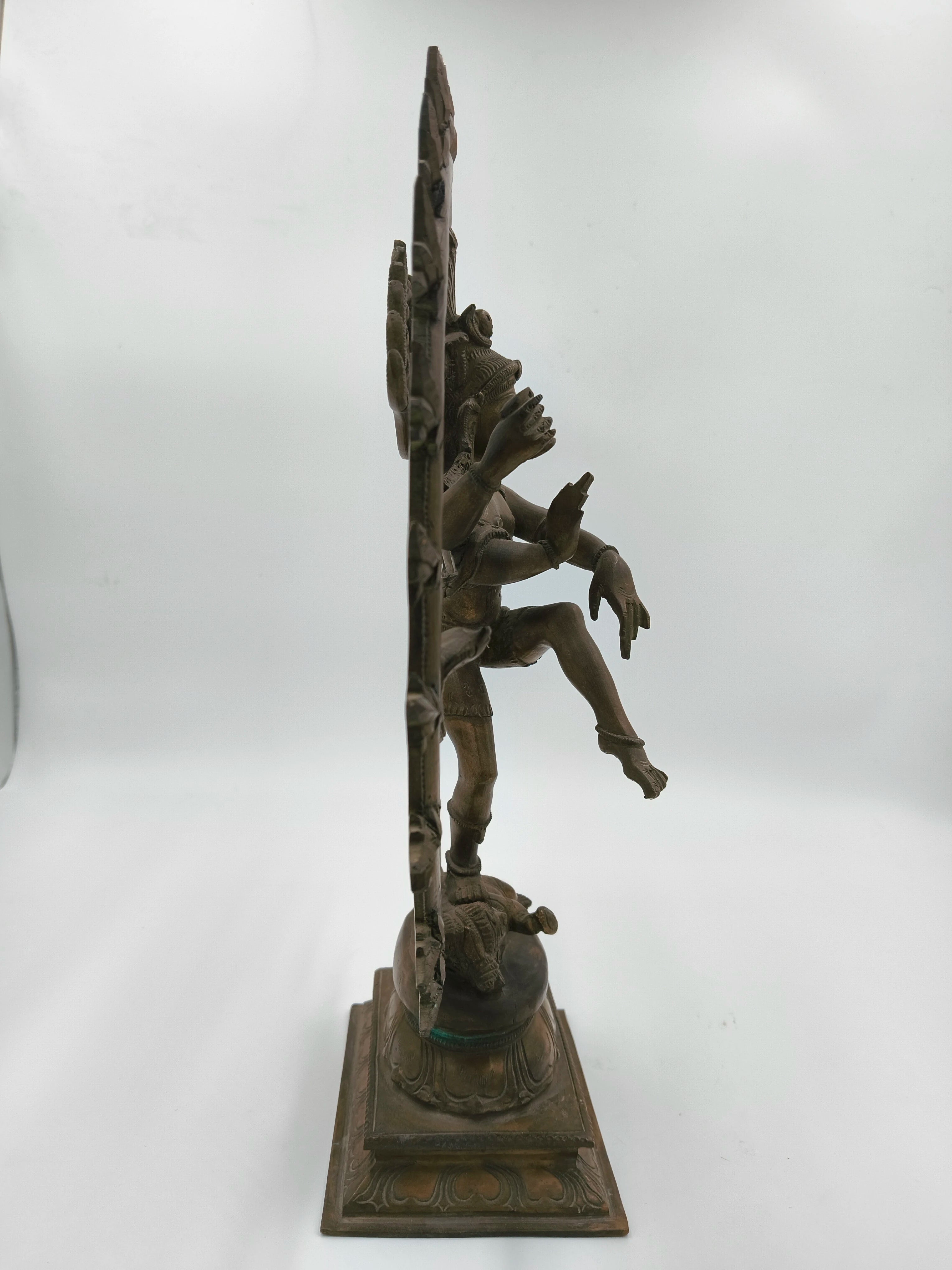 Side view of large bronze Nataraja statue depicting Shiva in cosmic dance
