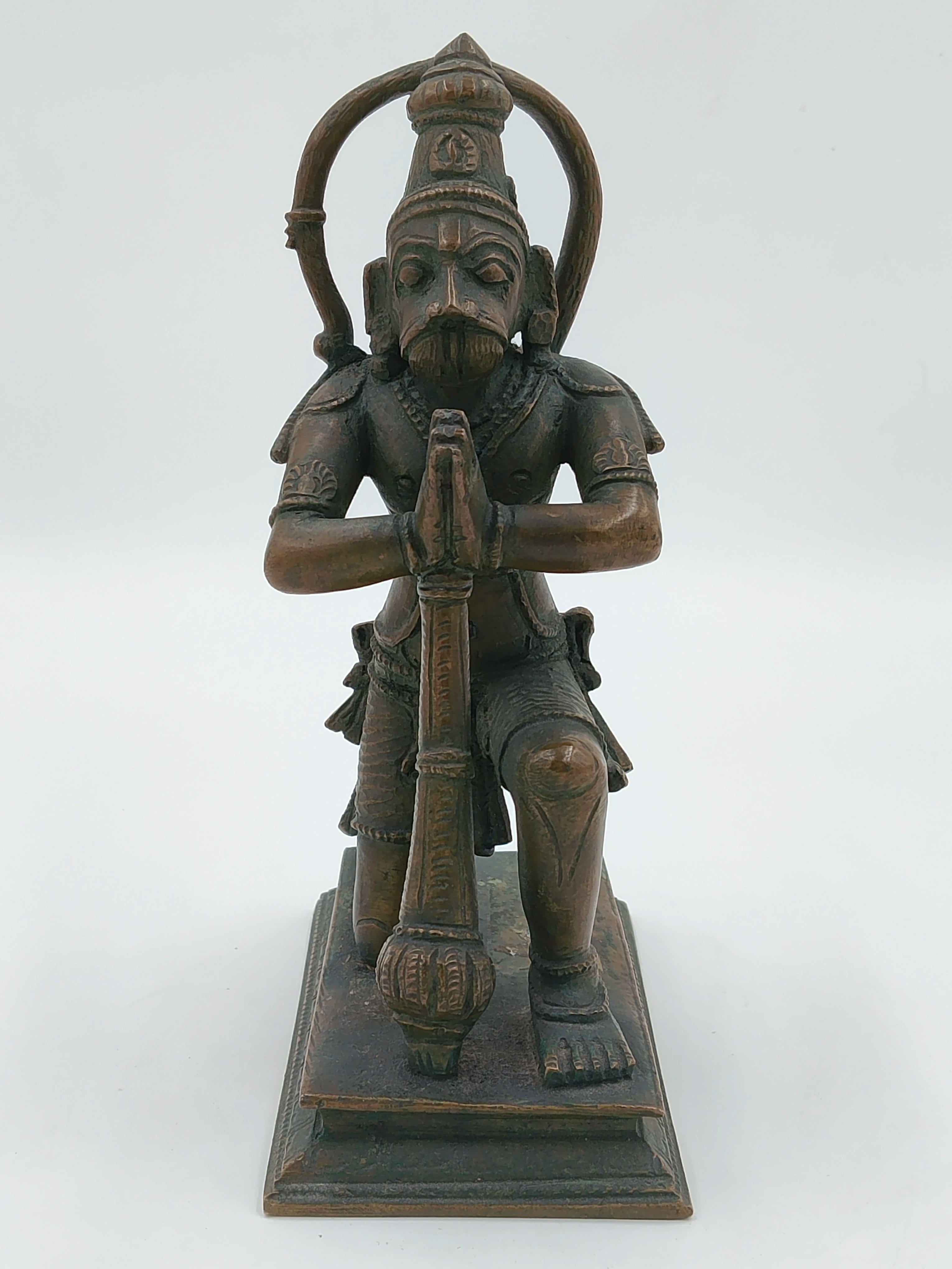Front view of bronze Hanuman statue kneeling with folded hands on a rectangular base