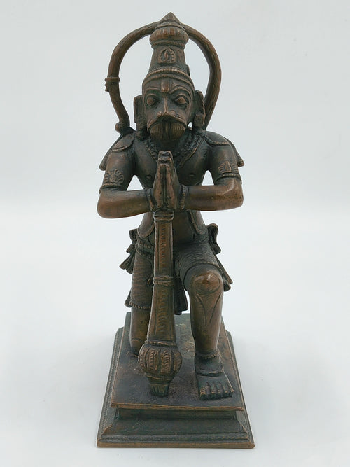 Front view of bronze Hanuman statue kneeling with folded hands on a rectangular base