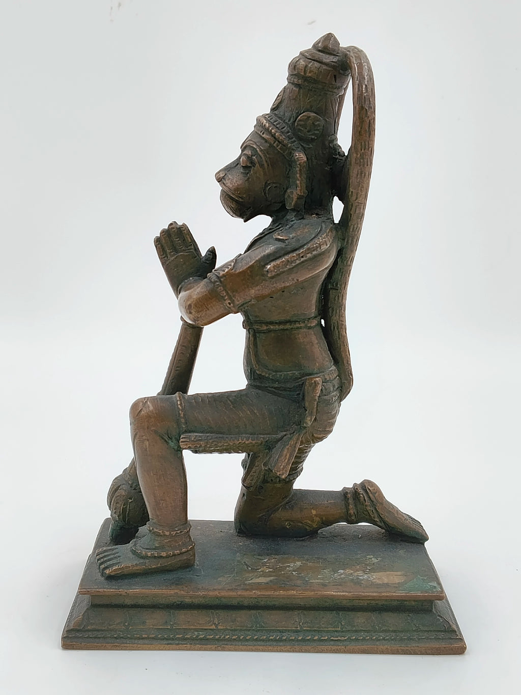Side view of a 7-inch bronze Hanuman sculpture kneeling with joined hands