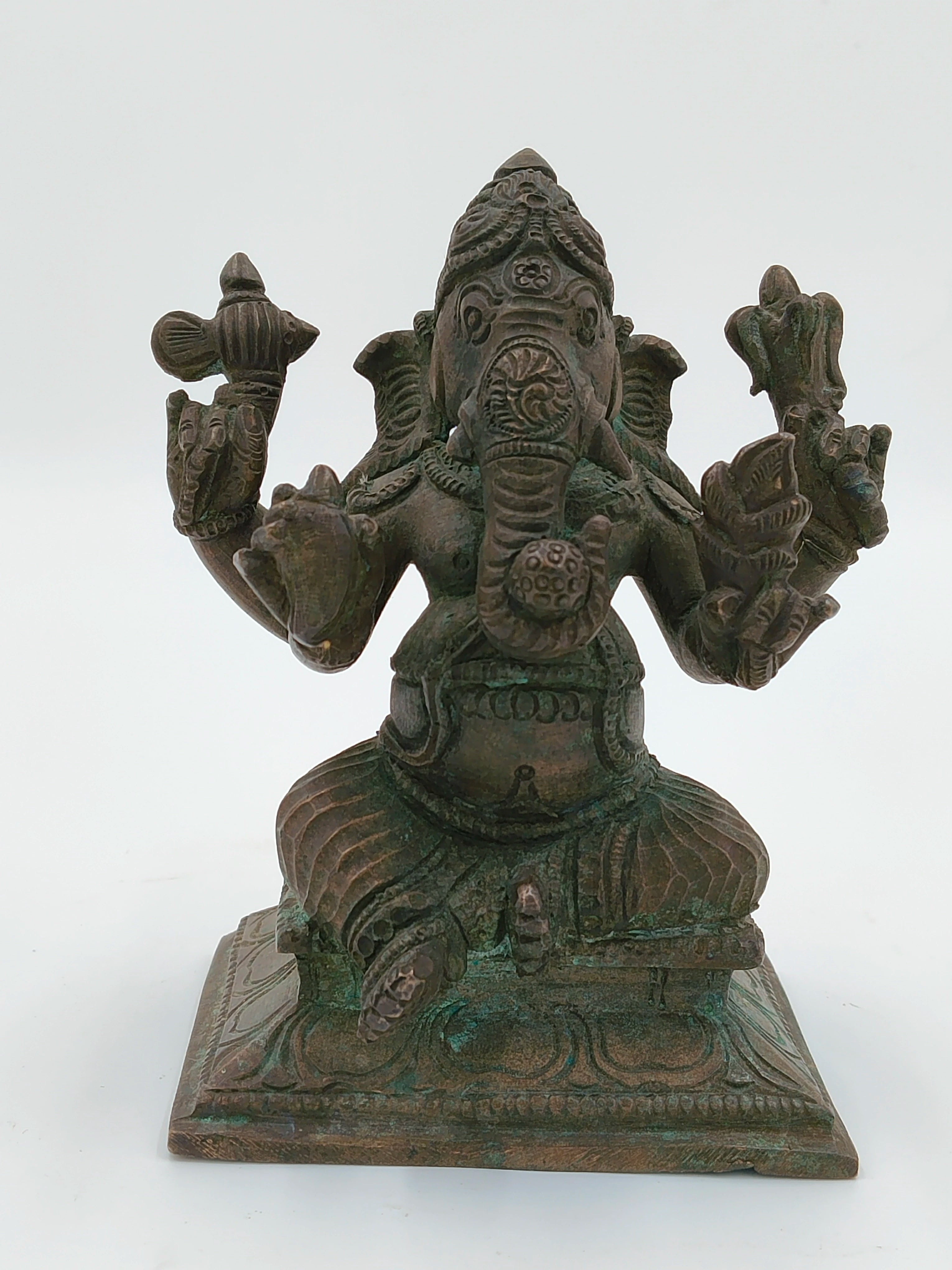 Front view of a medium-sized bronze Ganesh statue seated on a decorative base