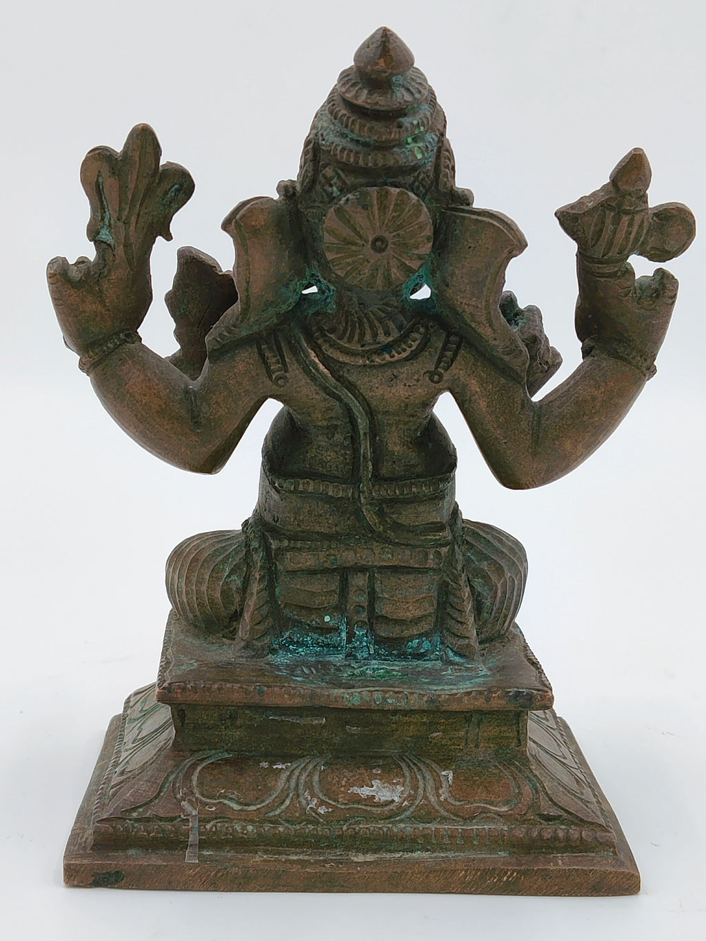 Back view of a medium bronze Ganesh statue seated on a decorative base