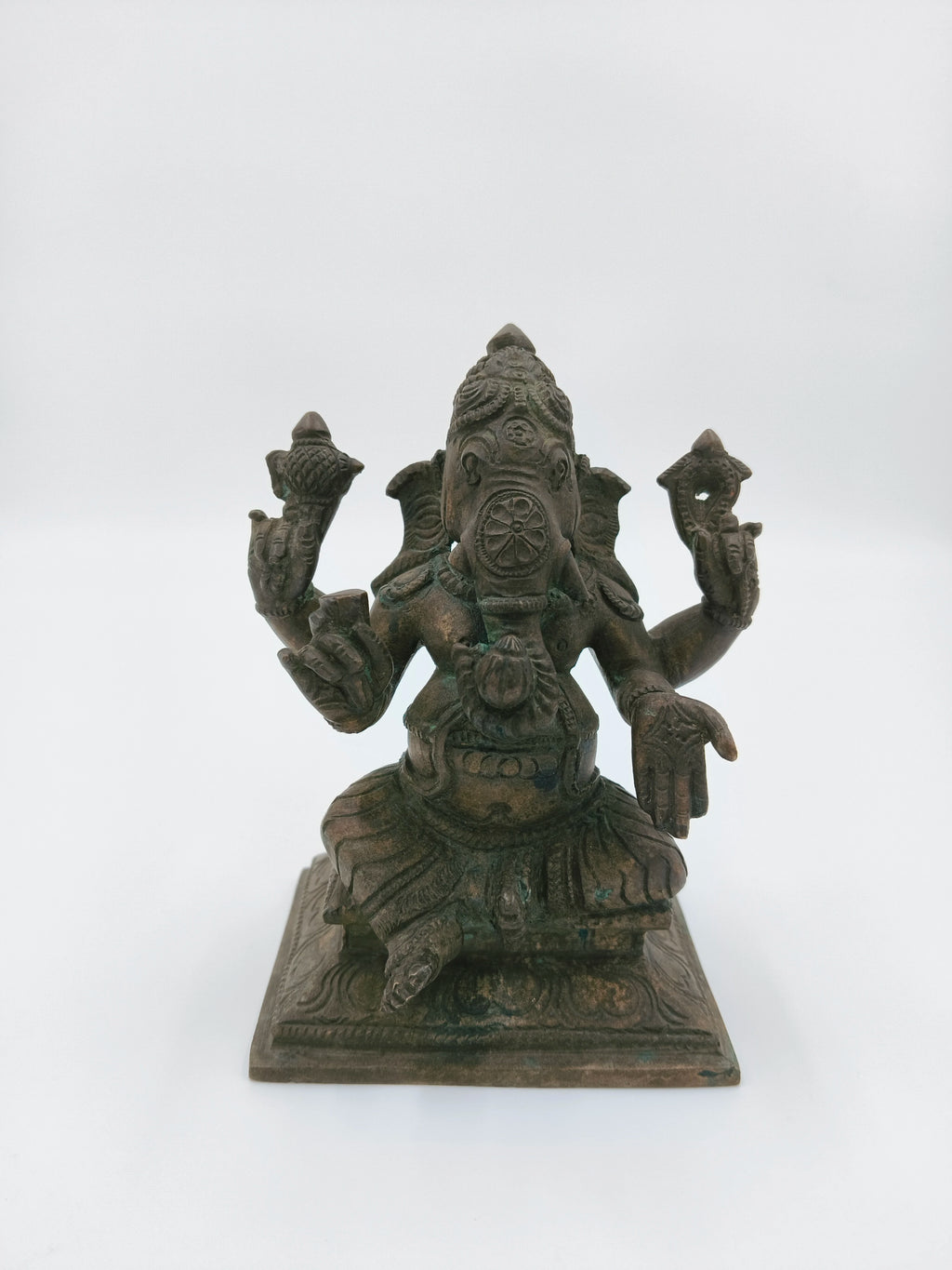 Front view of a 4.7 inch bronze Ganesh statue seated on a square base