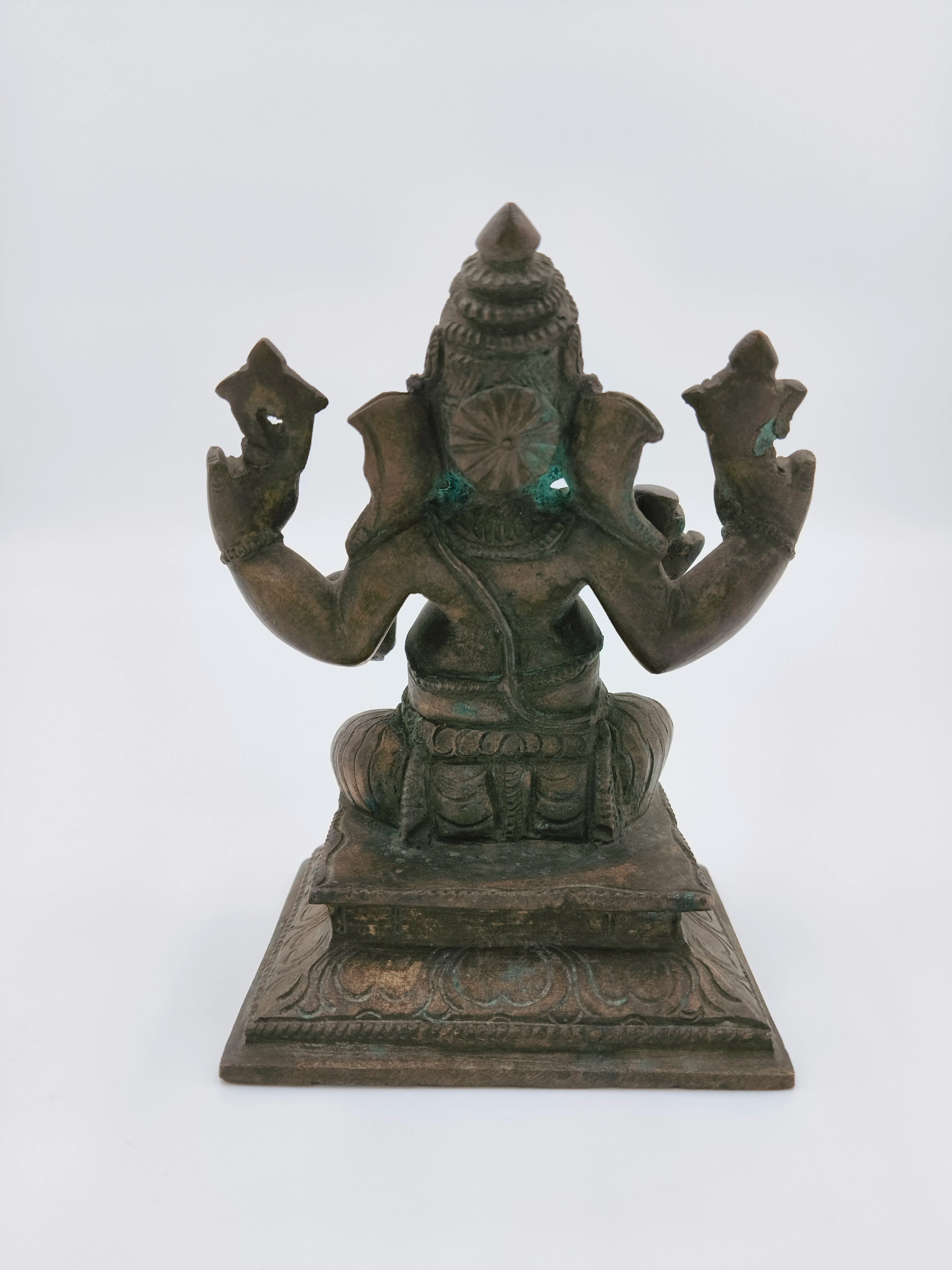 Rear view of medium-sized bronze Ganesh statue seated on an ornate base