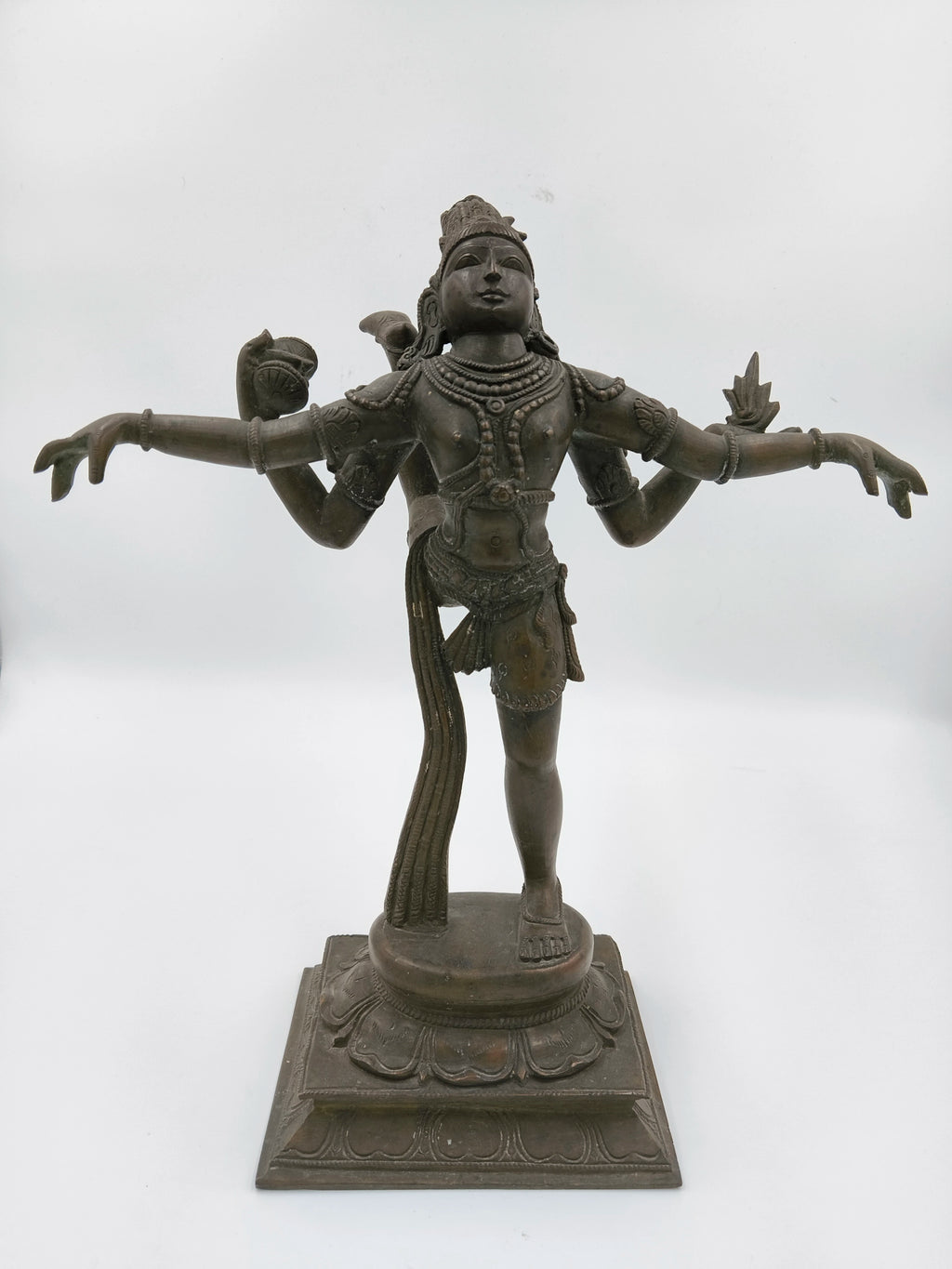 Bronze Nataraja statue with four arms in dancing pose on square pedestal