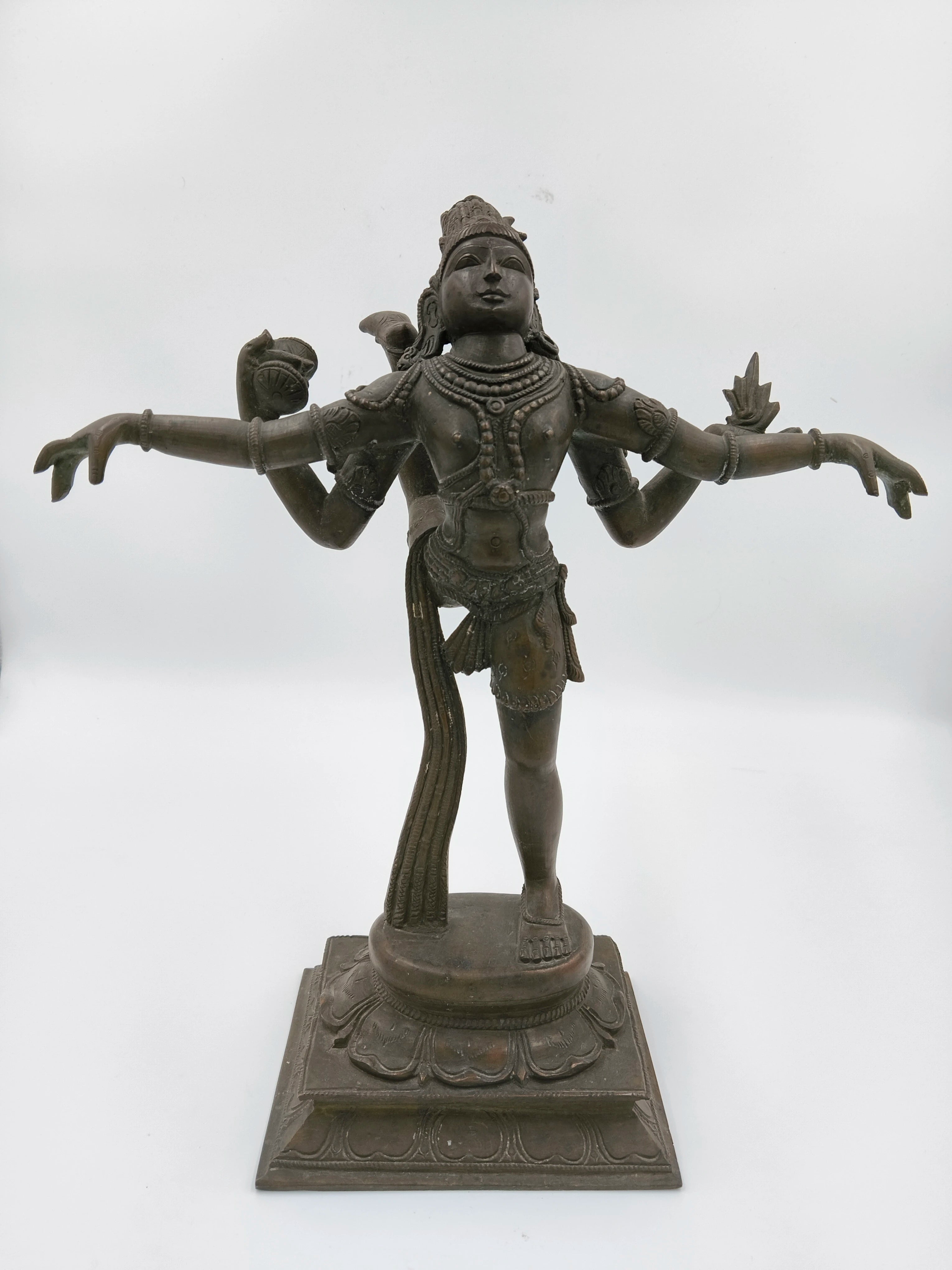 Bronze Nataraja statue with four arms in dancing pose on square pedestal