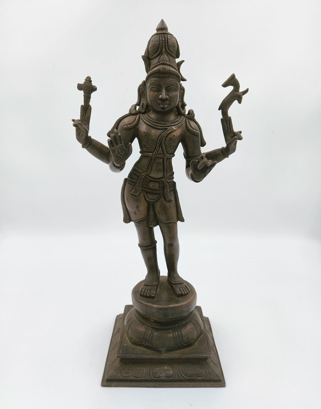 Bronze sculpture of Hindu deity Shiva standing on ornate pedestal