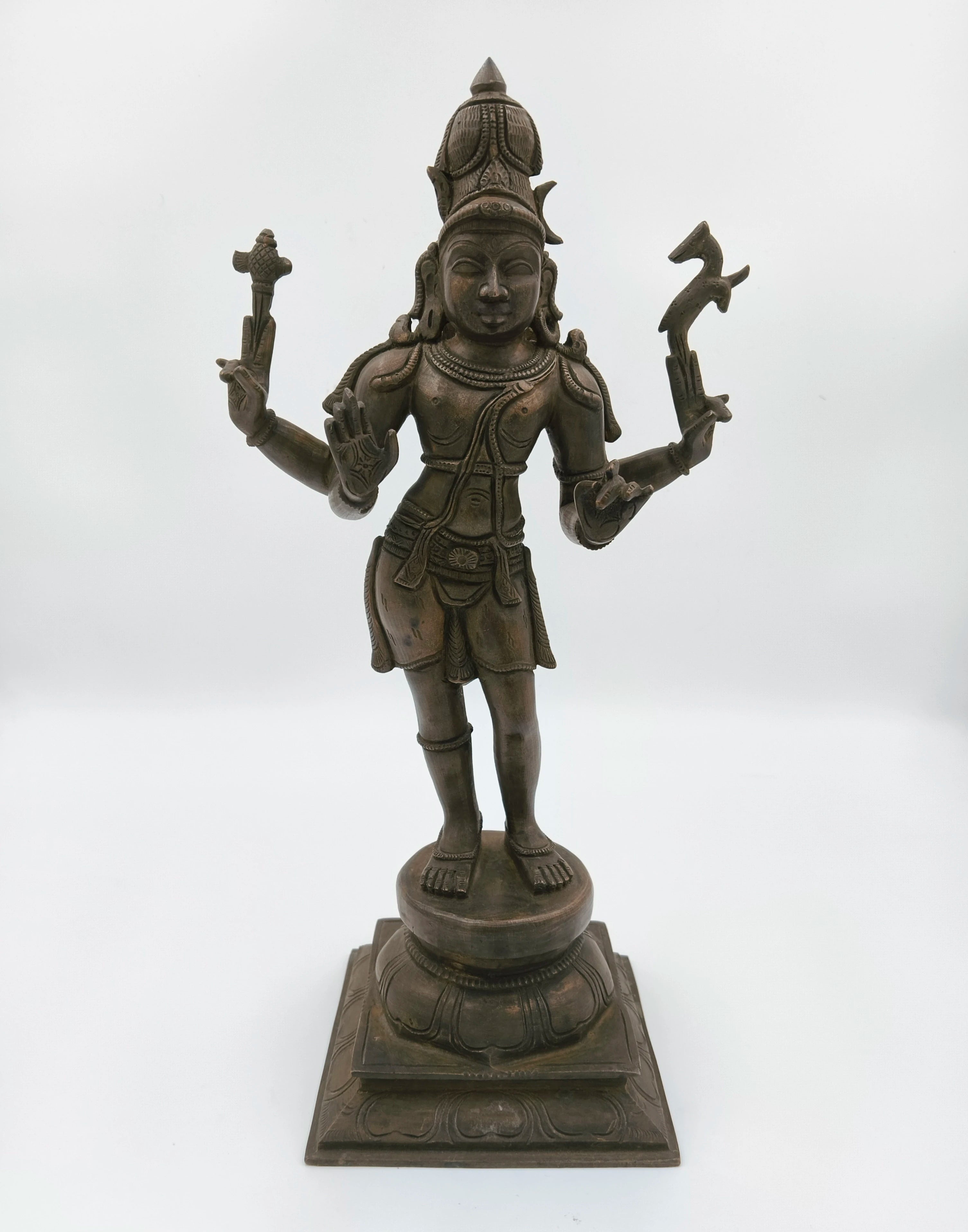 Bronze sculpture of Hindu deity Shiva standing on ornate pedestal