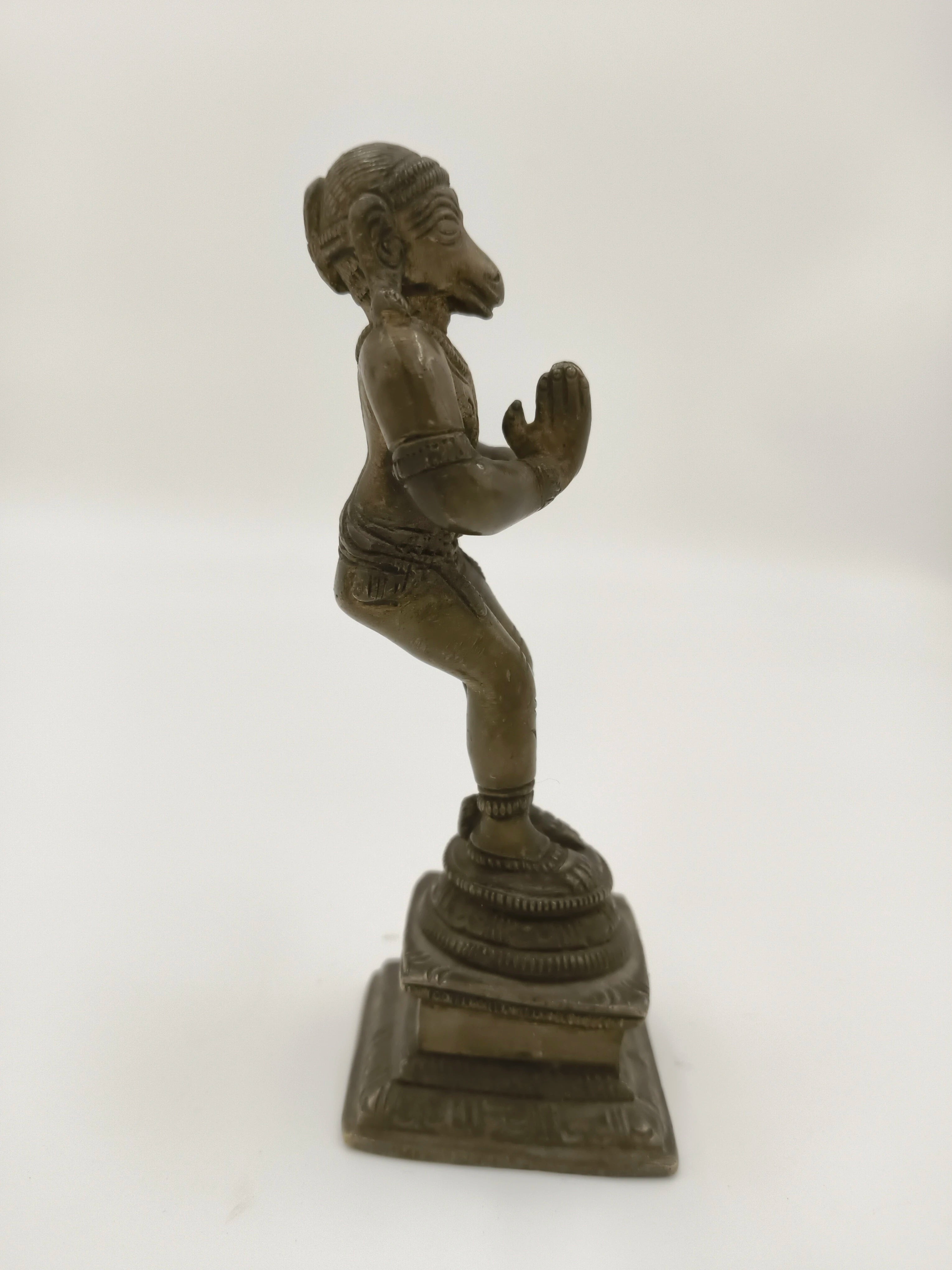Side view of 4.5 inch bronze Hanuman statue with folded hands on pedestal