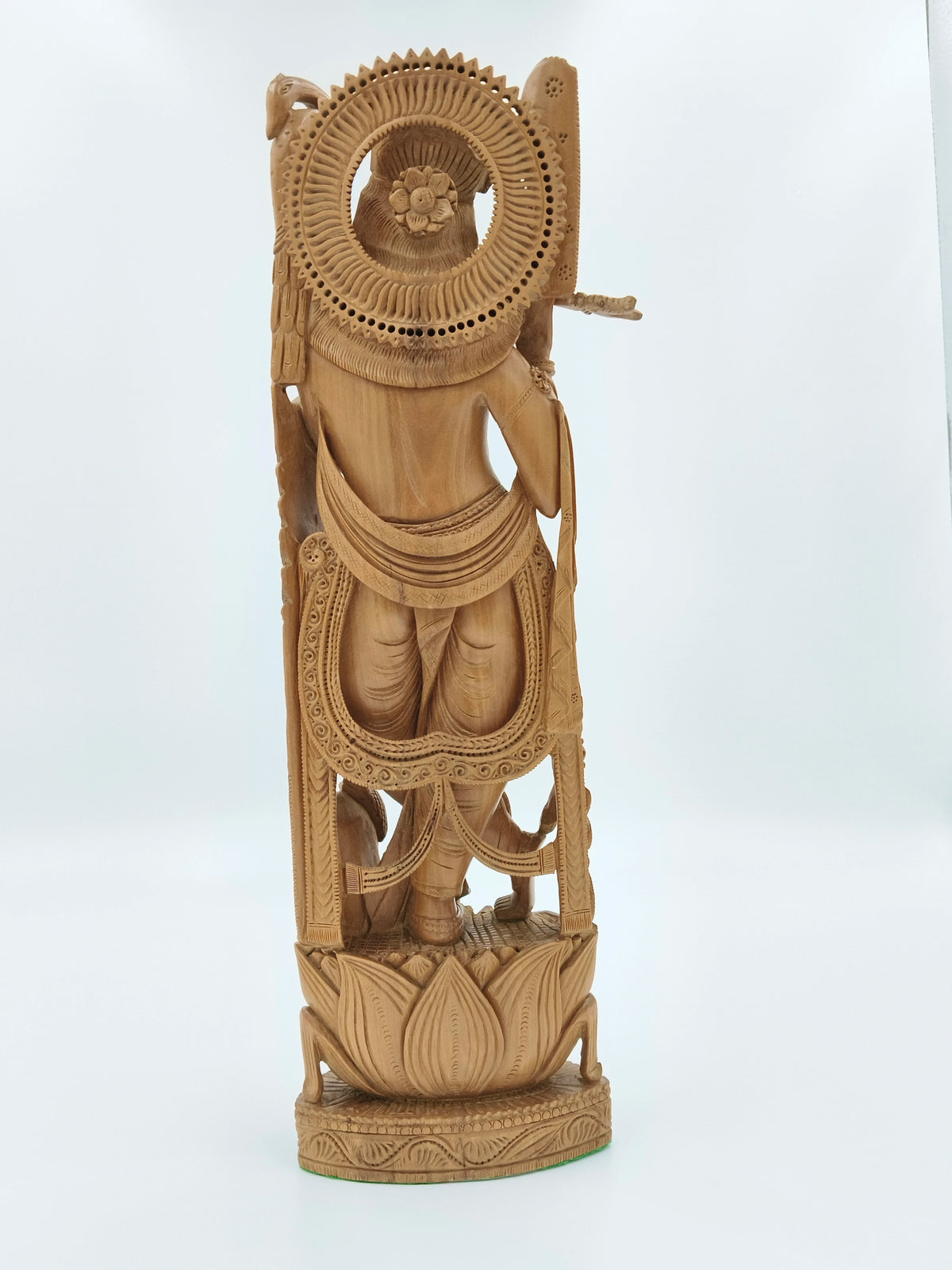 Back view of large sandalwood Krishna idol with intricate wood carving