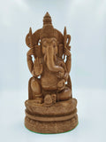 Large sandalwood carved Ganesh statue with intricate detailing, sitting on lotus pedestal
