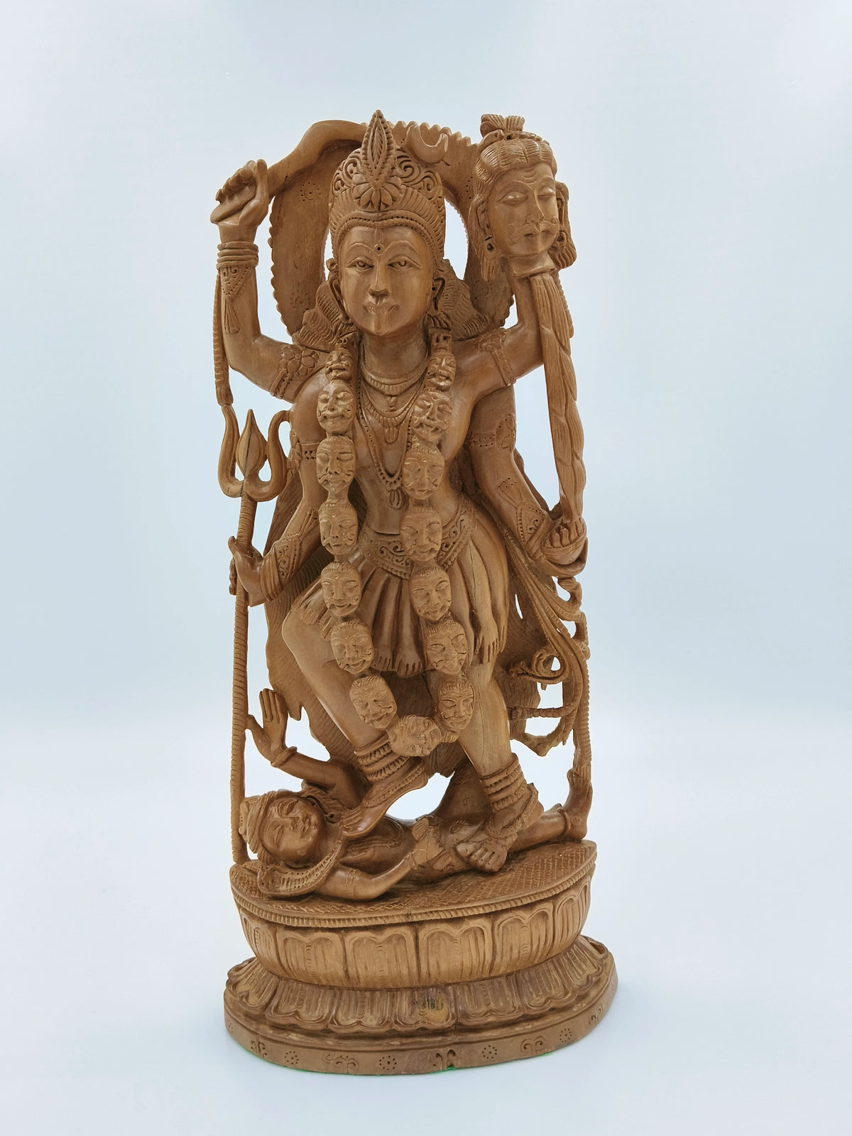 Large sandalwood Kali idol sculpture with multiple arms and detailed carvings
