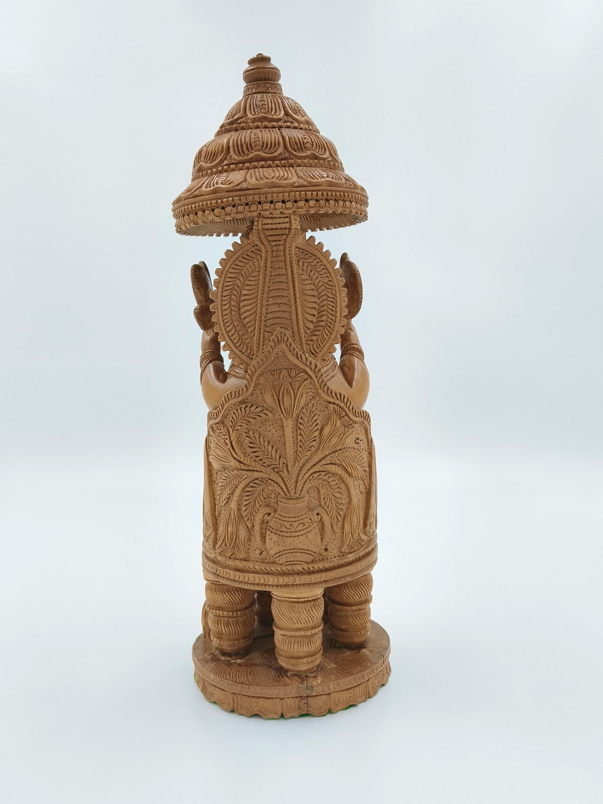 Back view of large sandalwood Ganesh idol with carved floral details