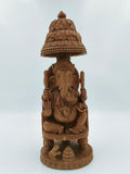 Sandalwood Ganesh idol seated on ornate throne with canopy and small mouse figurine