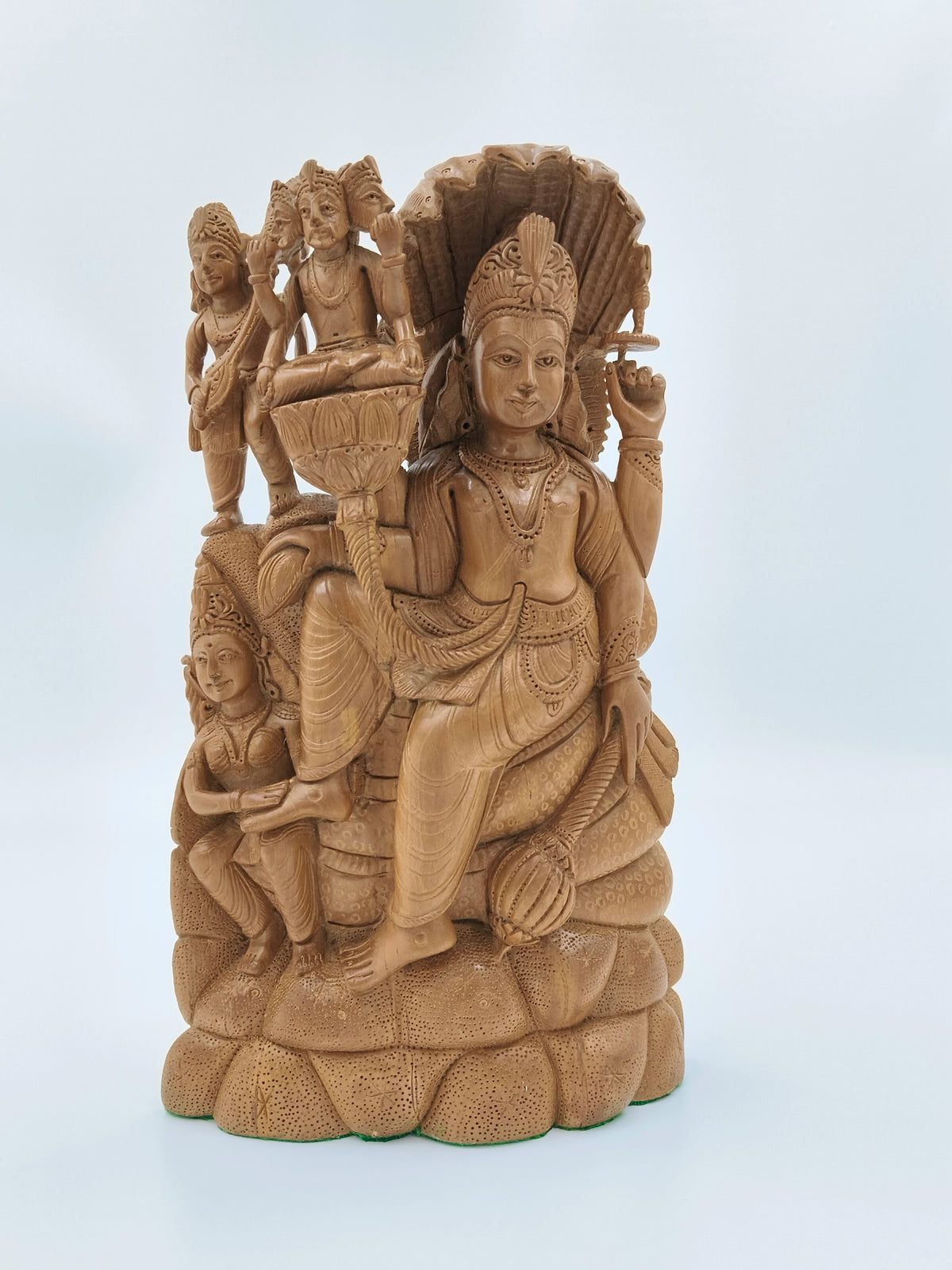 Large sandalwood idol of Vishnu seated on serpent with detailed carvings