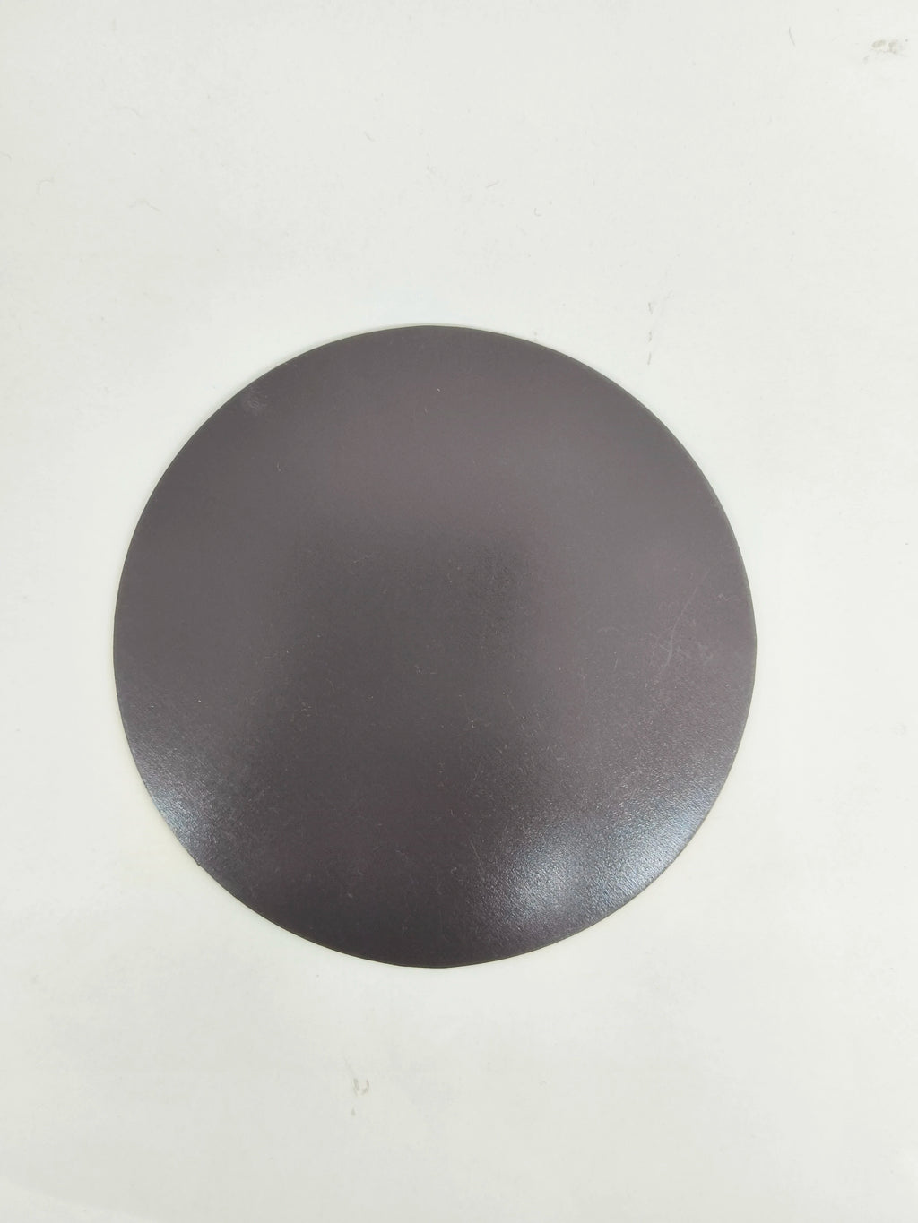 Large round black motivational fridge magnet back view