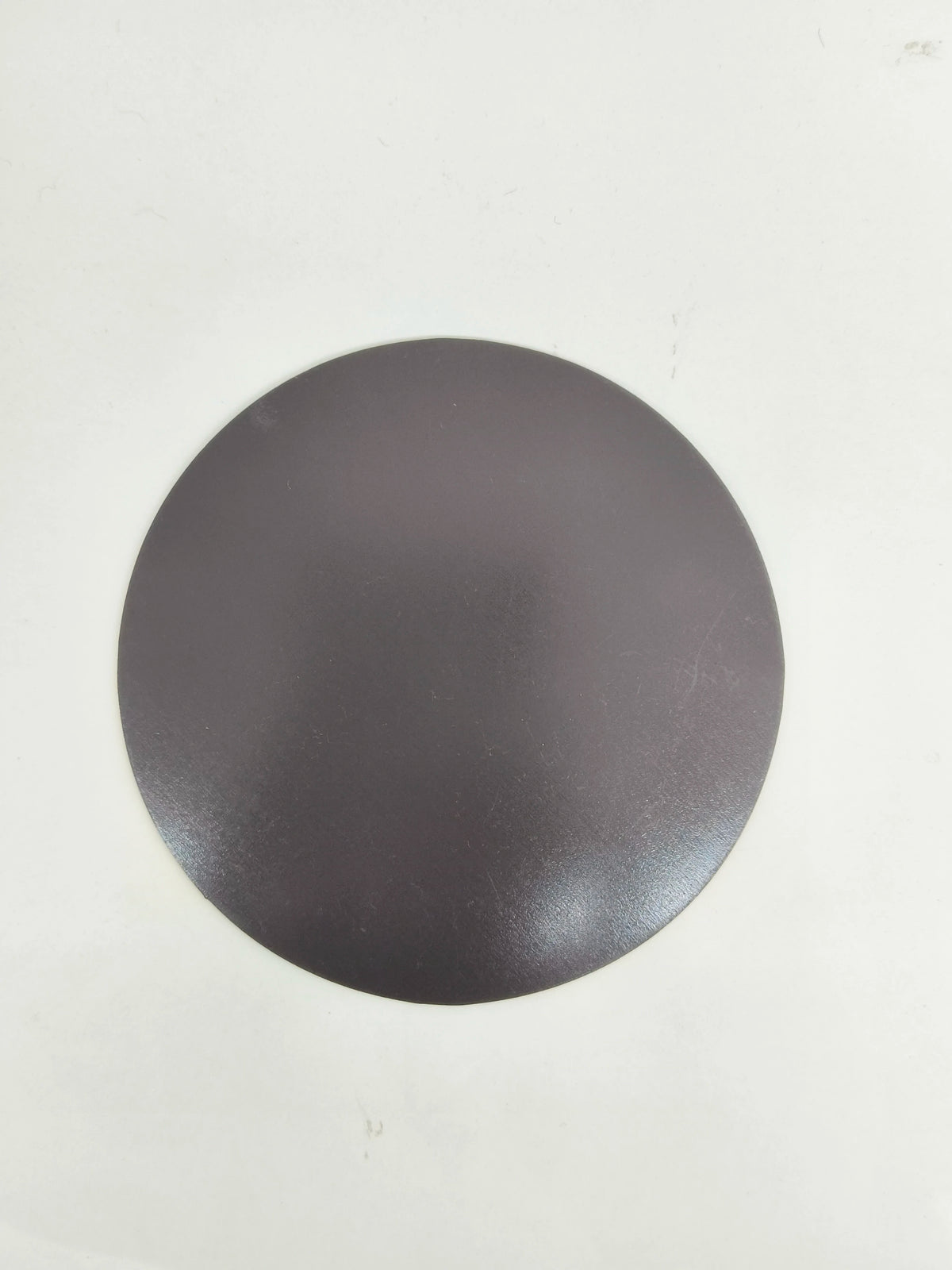 Large round black motivational fridge magnet back view