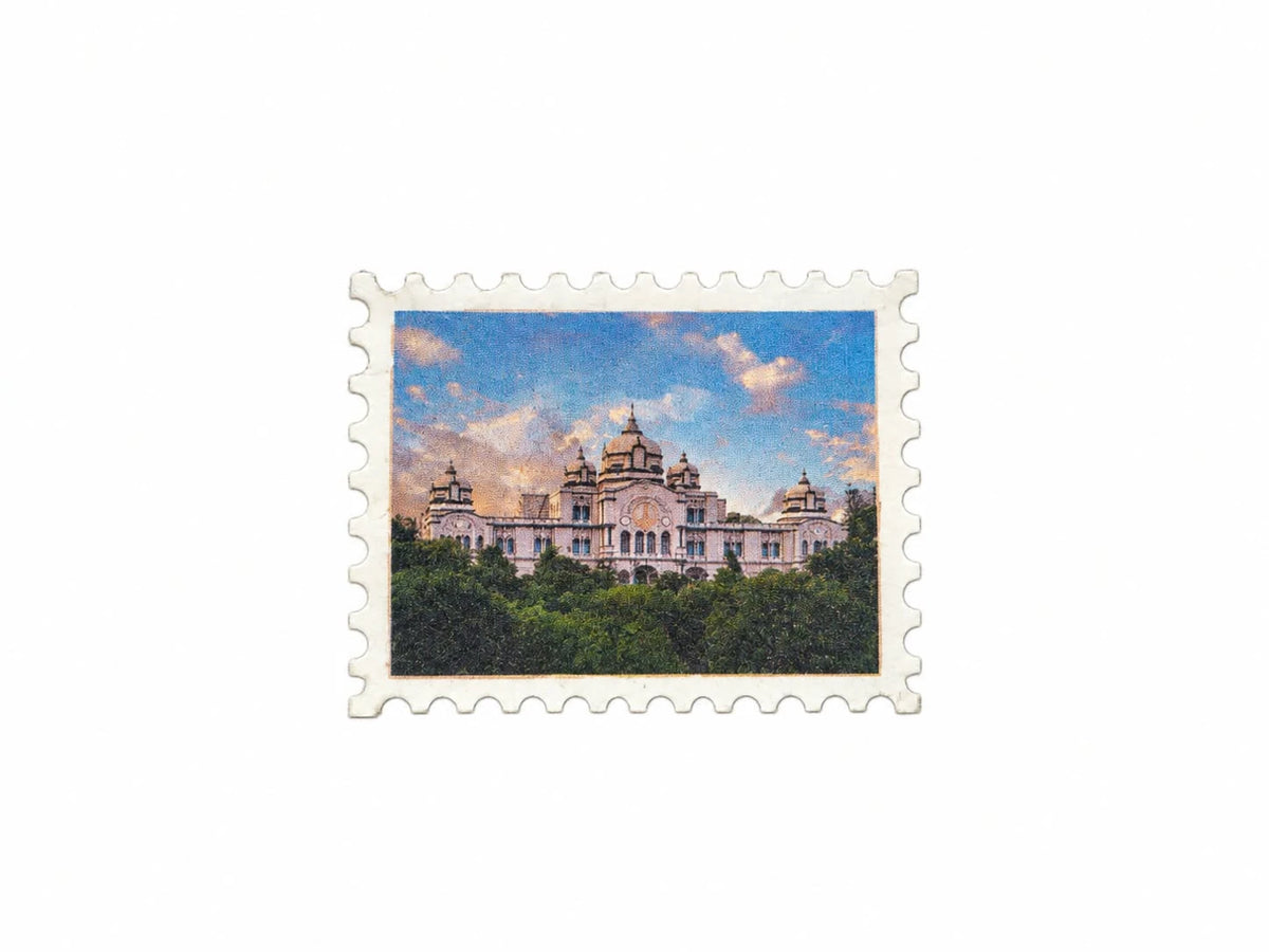 Small rectangular university fridge magnet with building image and sky background