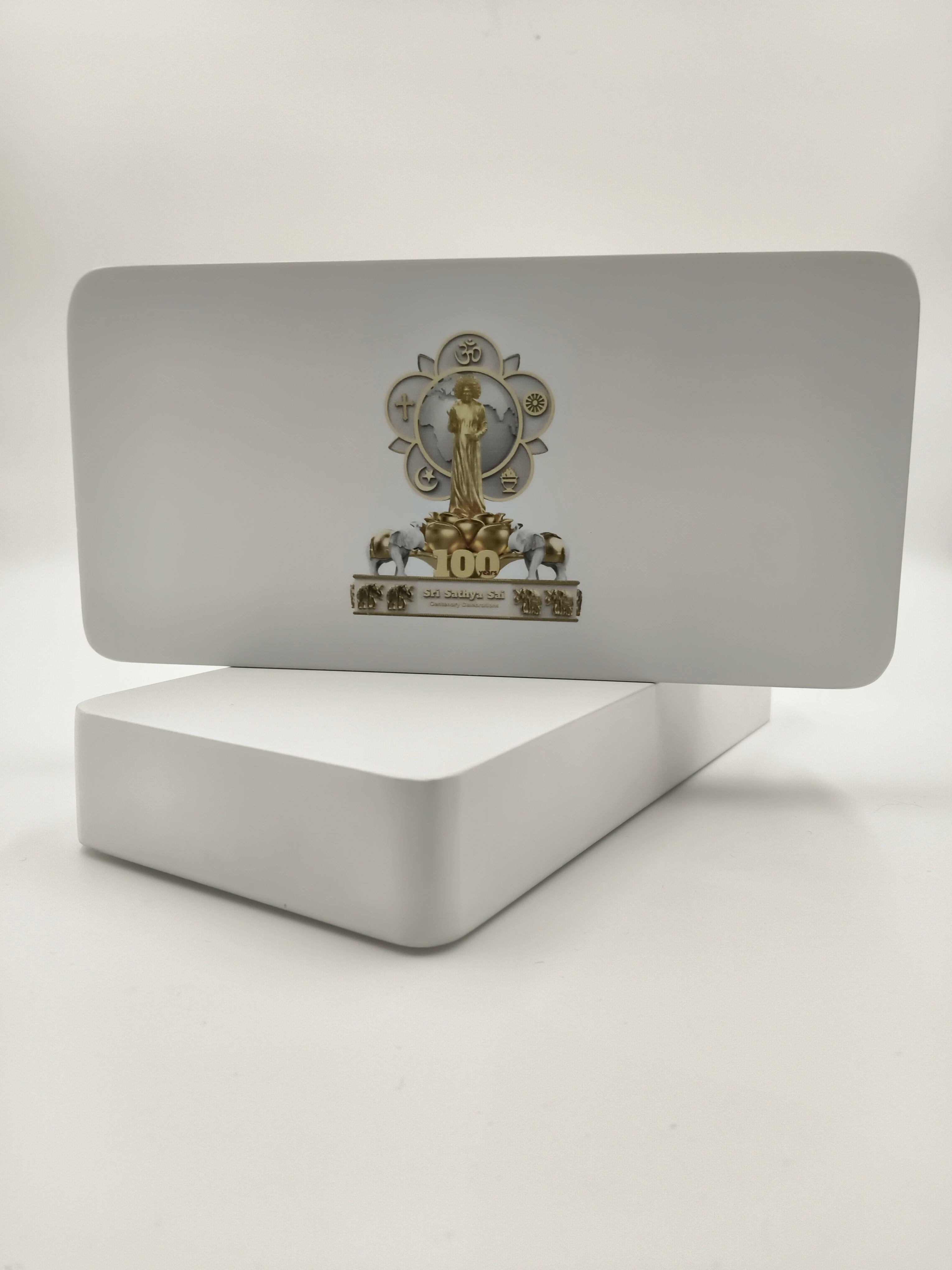 Wooden tabletop clock with Sri Sathya Sai Baba centenary logo and golden decorative elements