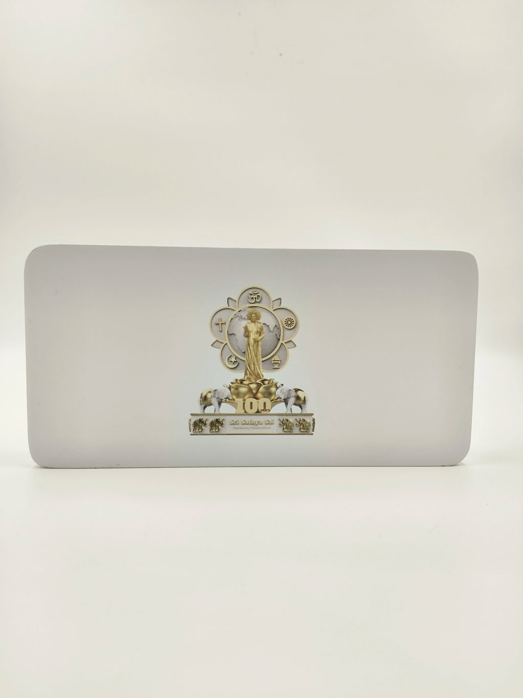 Wooden tabletop clock with Sri Sathya Sai Baba centenary logo and decorative elements