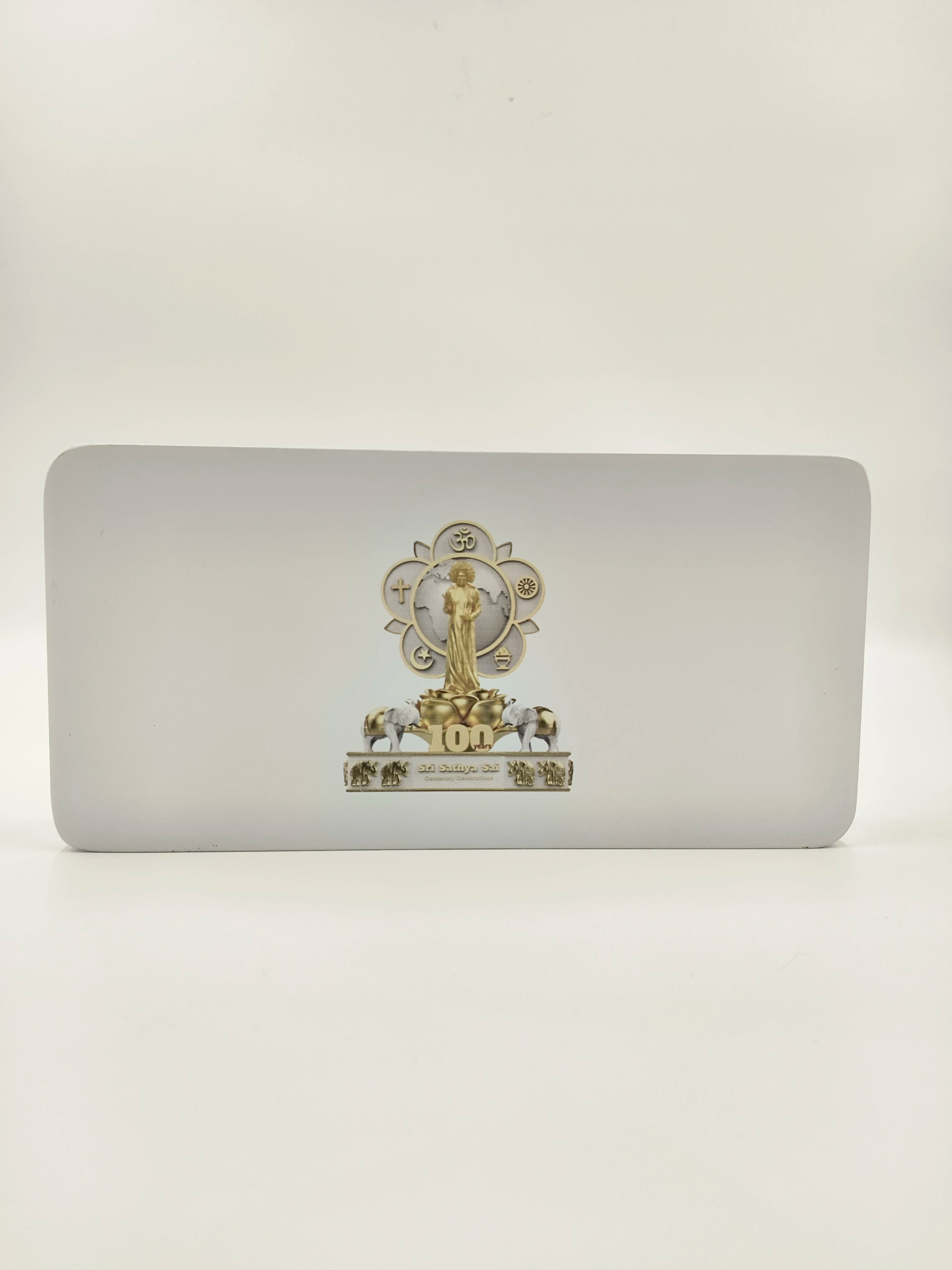 Wooden tabletop clock with Sri Sathya Sai Baba centenary logo and decorative elements