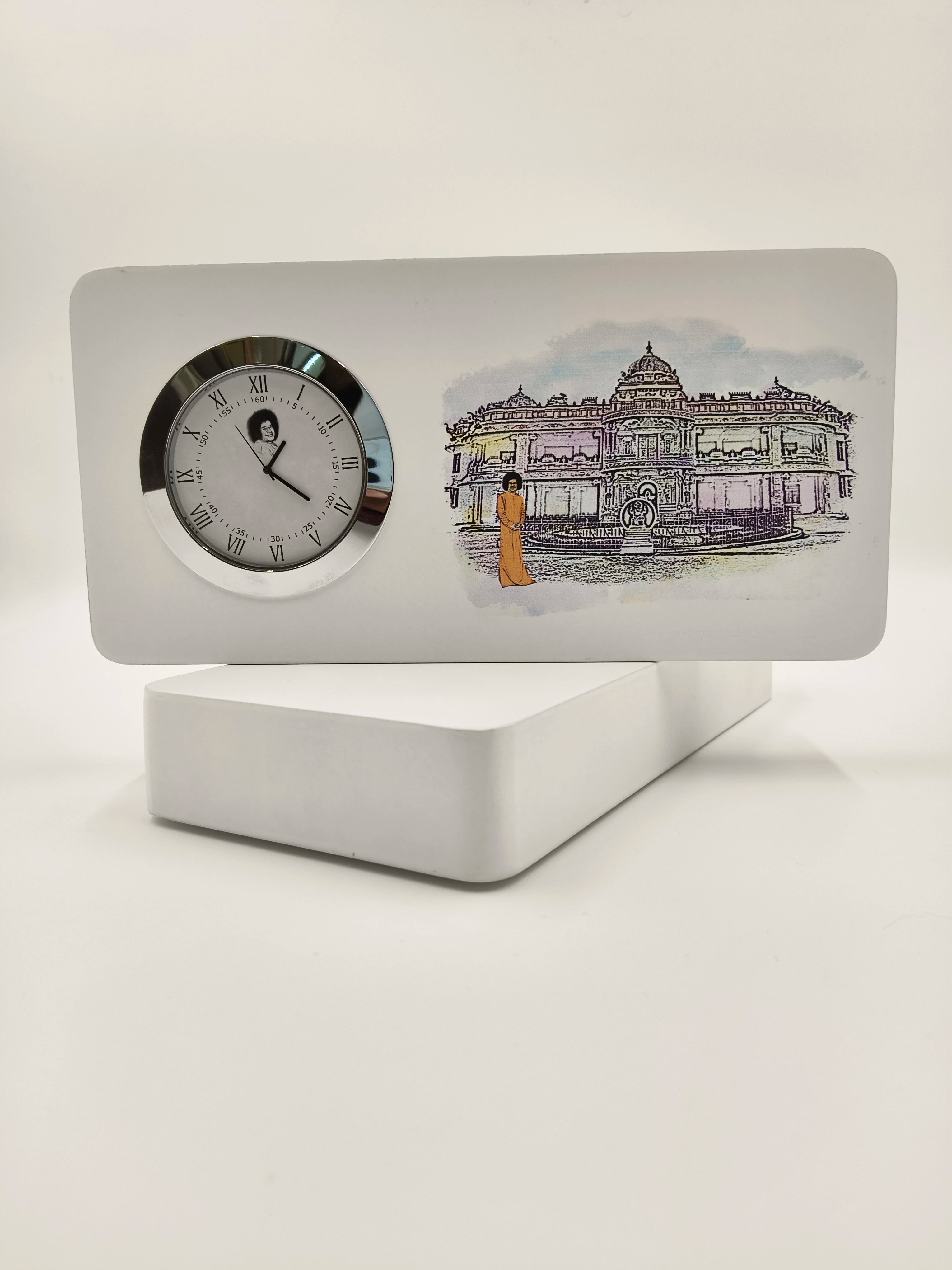 Small wooden tabletop clock with Prashanthi Nilayam logo and Sai Baba figure