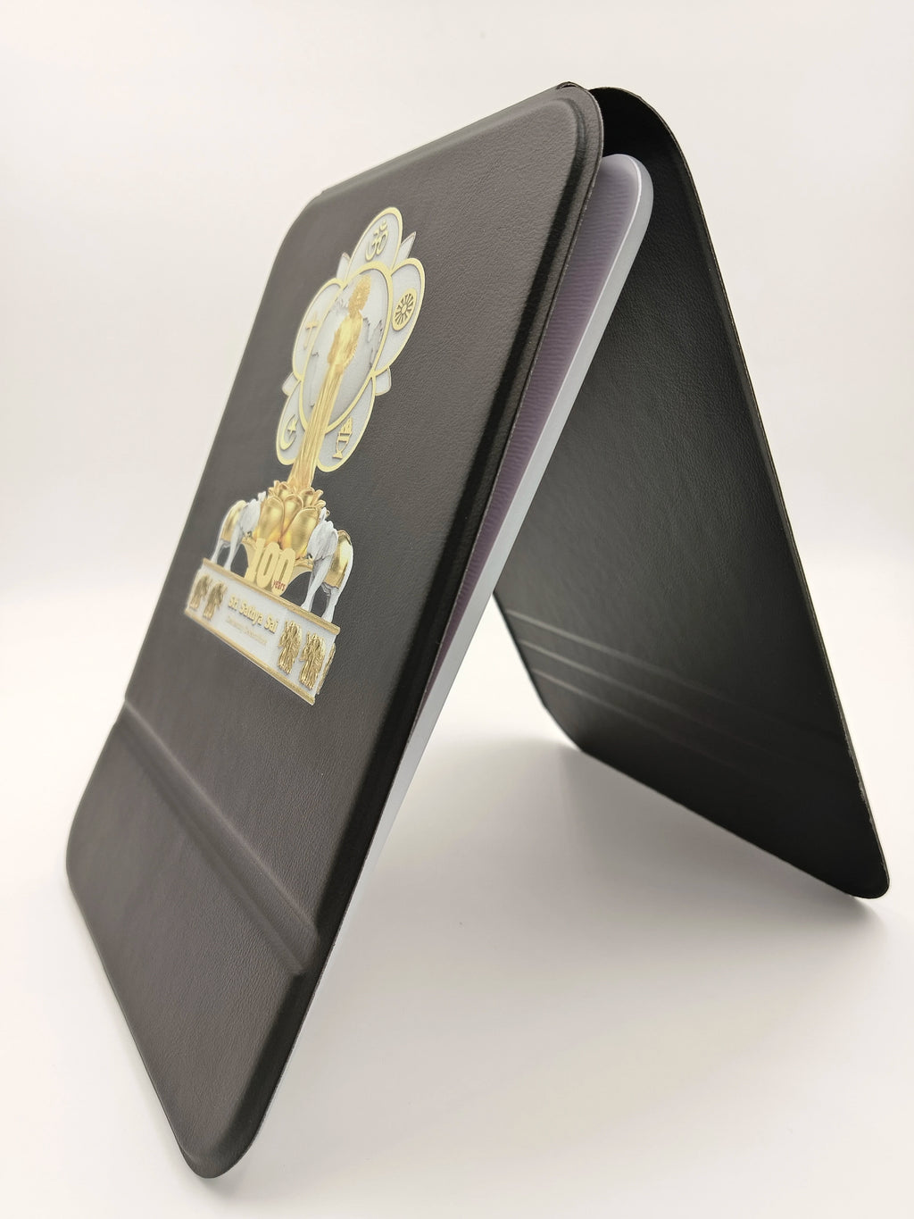 Black wooden board with Sri Sathya Sai Baba centenary celebration logo and symbols