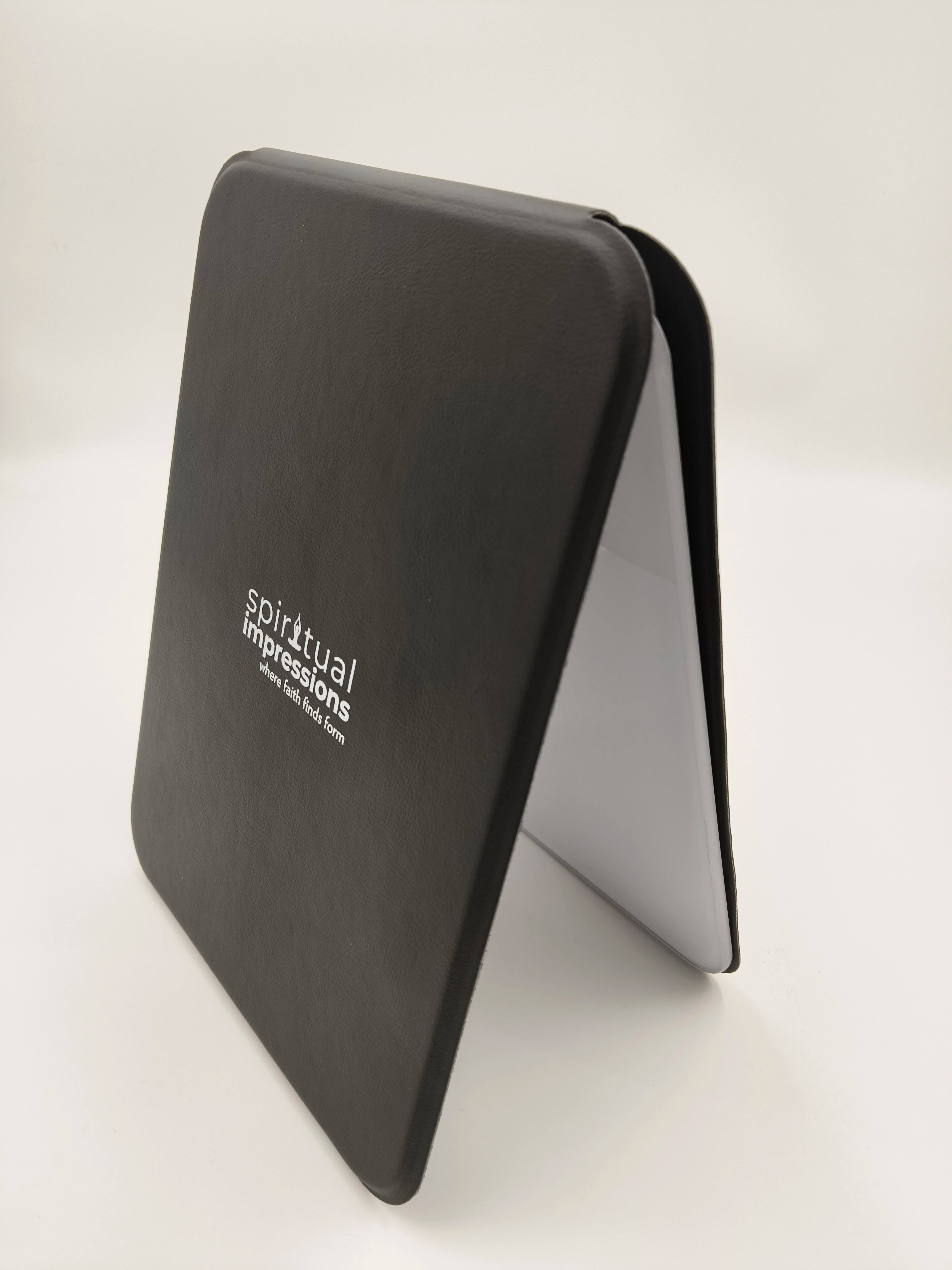 Black wooden board with Spiritual Impressions logo, standing angled
