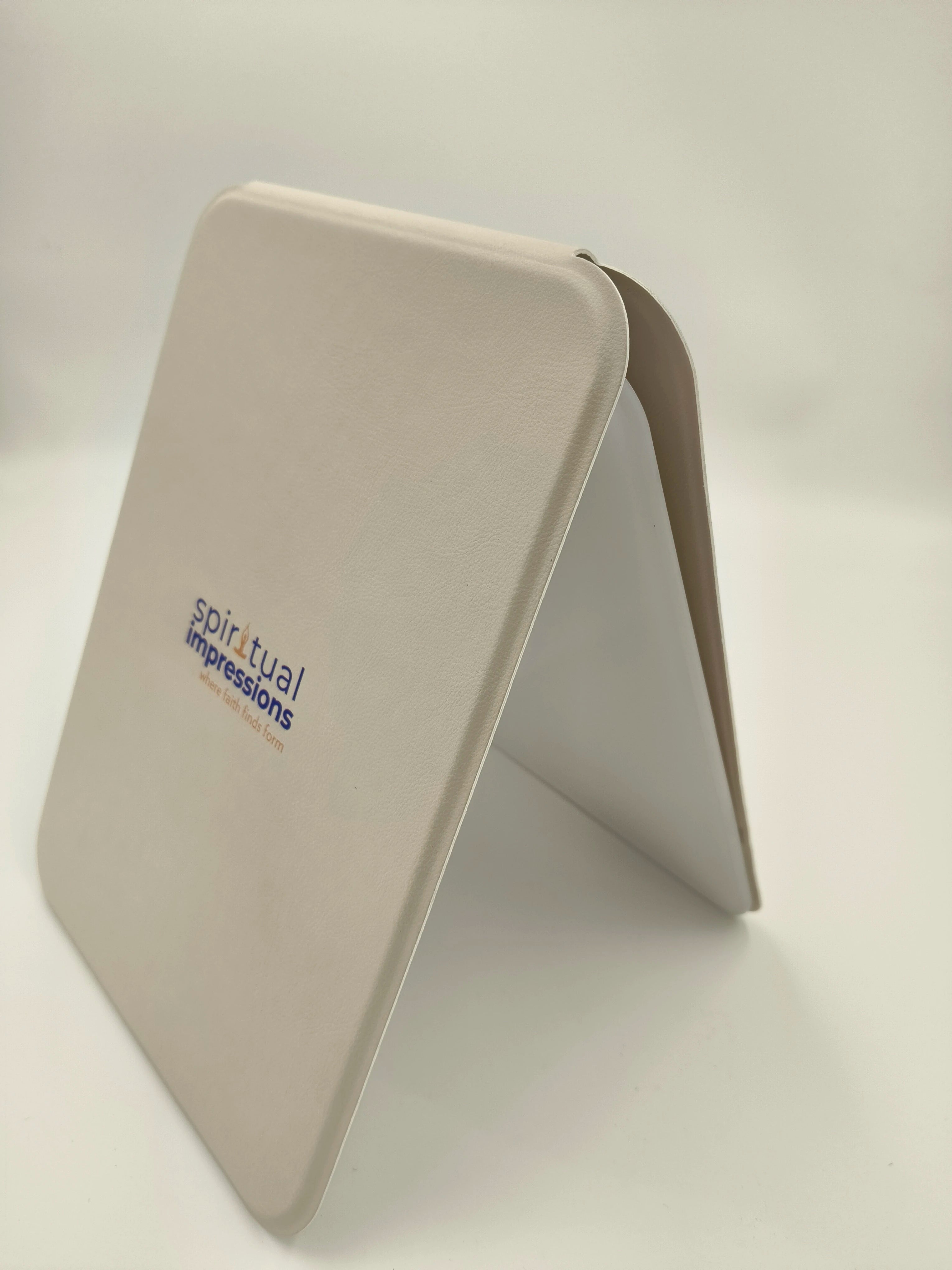 White wooden board with Spiritual Impressions logo, standing upright