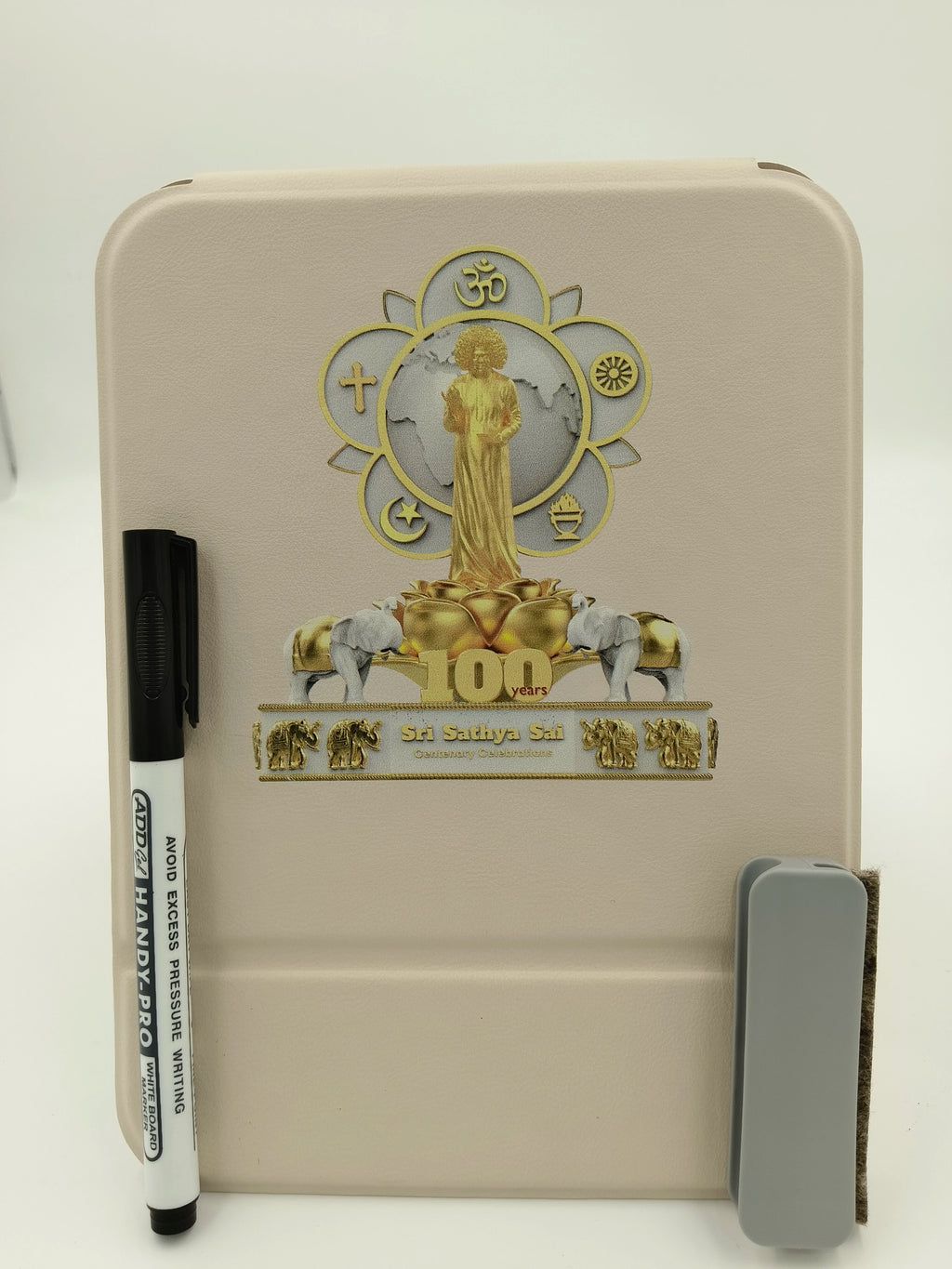White board with Sri Sathya Sai Baba centenary celebration logo and attached marker