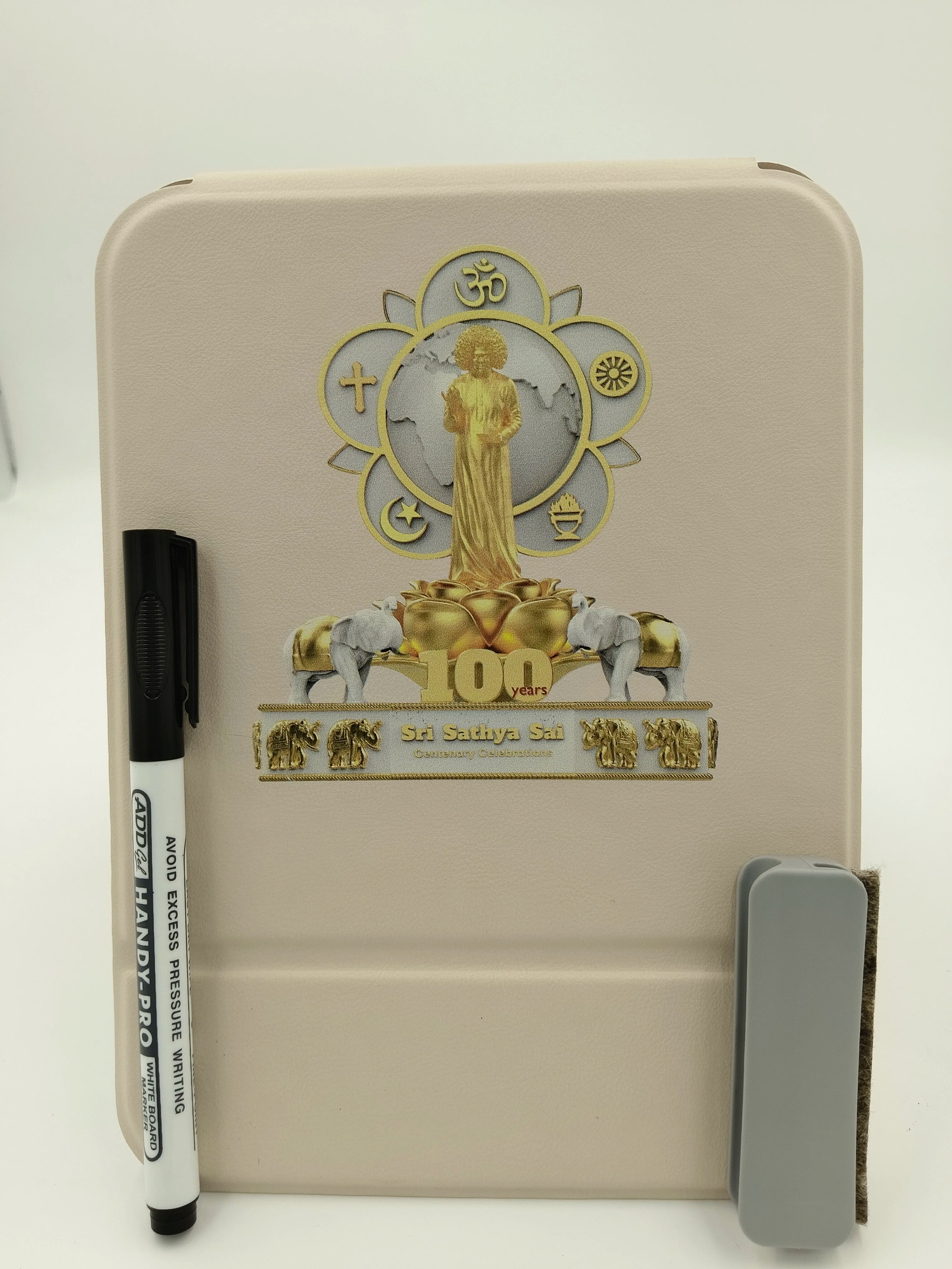 White board with Sri Sathya Sai Baba centenary celebration logo and attached marker